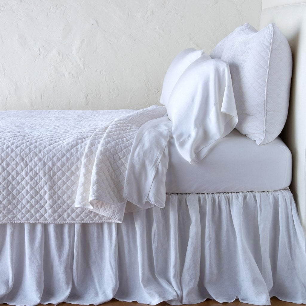White: shams with matching coverlet and white sheeting - side view.