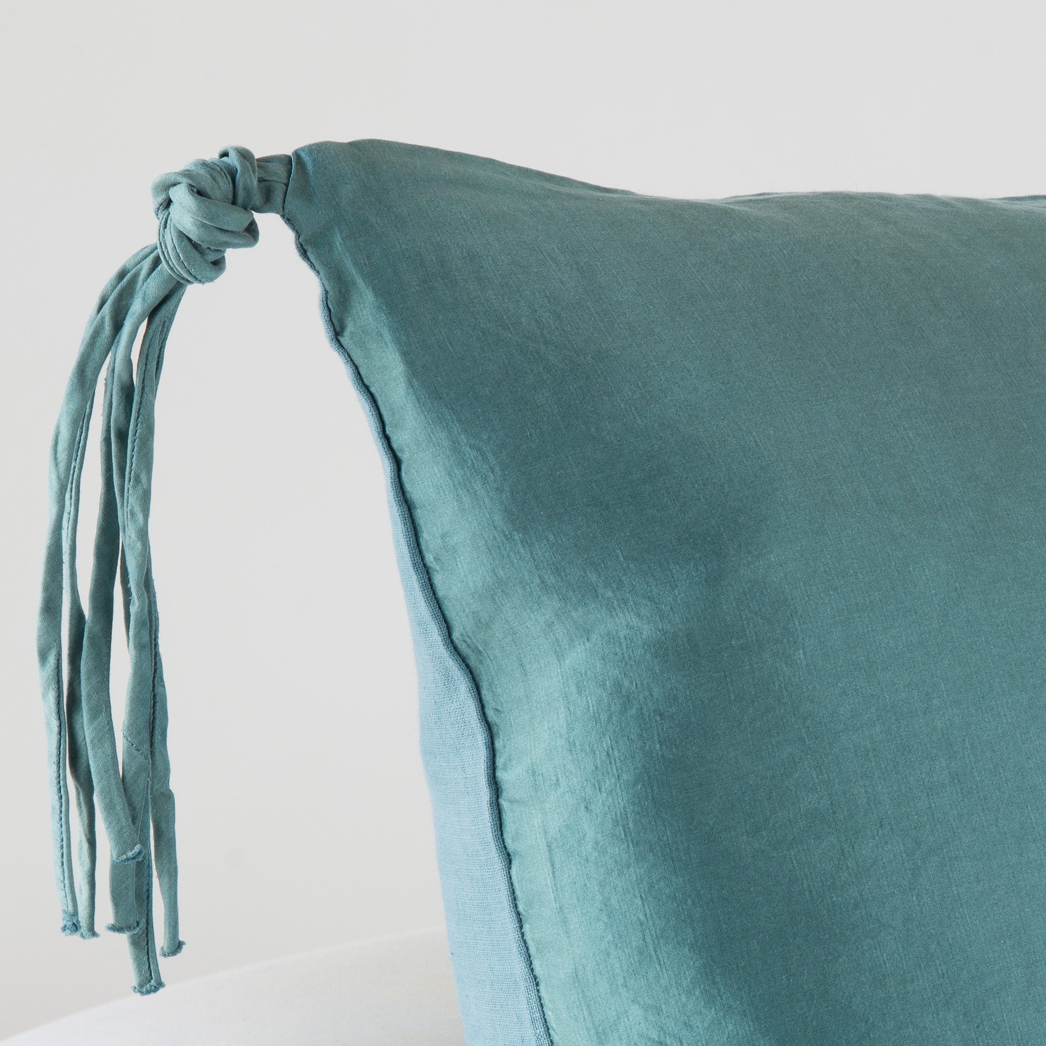 Cenote: Corner detail close-up, highlighting hand-tied charmeuse tassel.