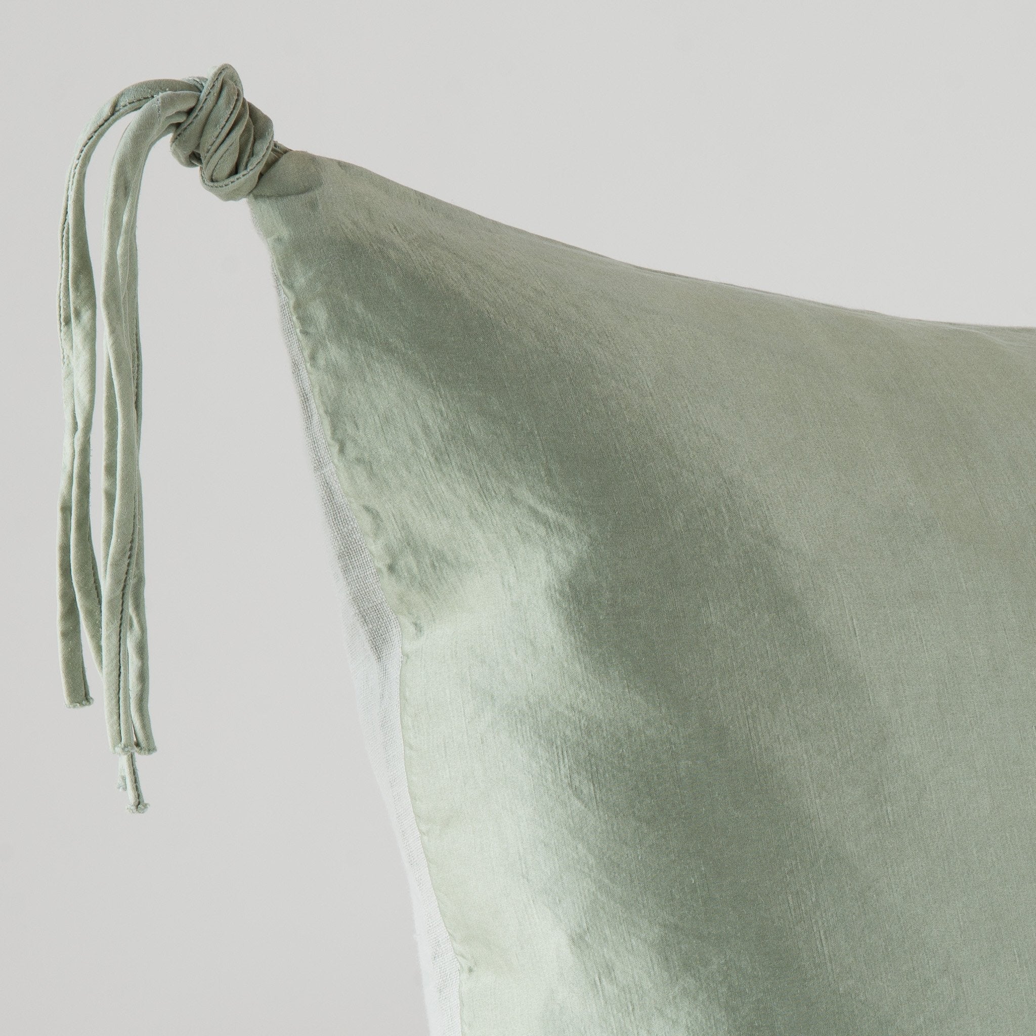 Eucalyptus: Corner detail close-up, highlighting hand-tied charmeuse tassel.