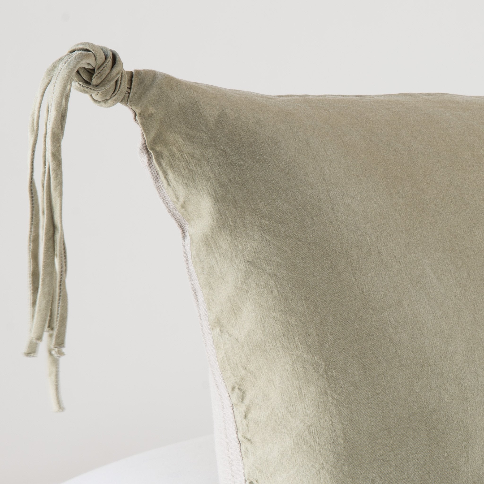 Fog: Corner detail close-up, highlighting hand-tied charmeuse tassel.