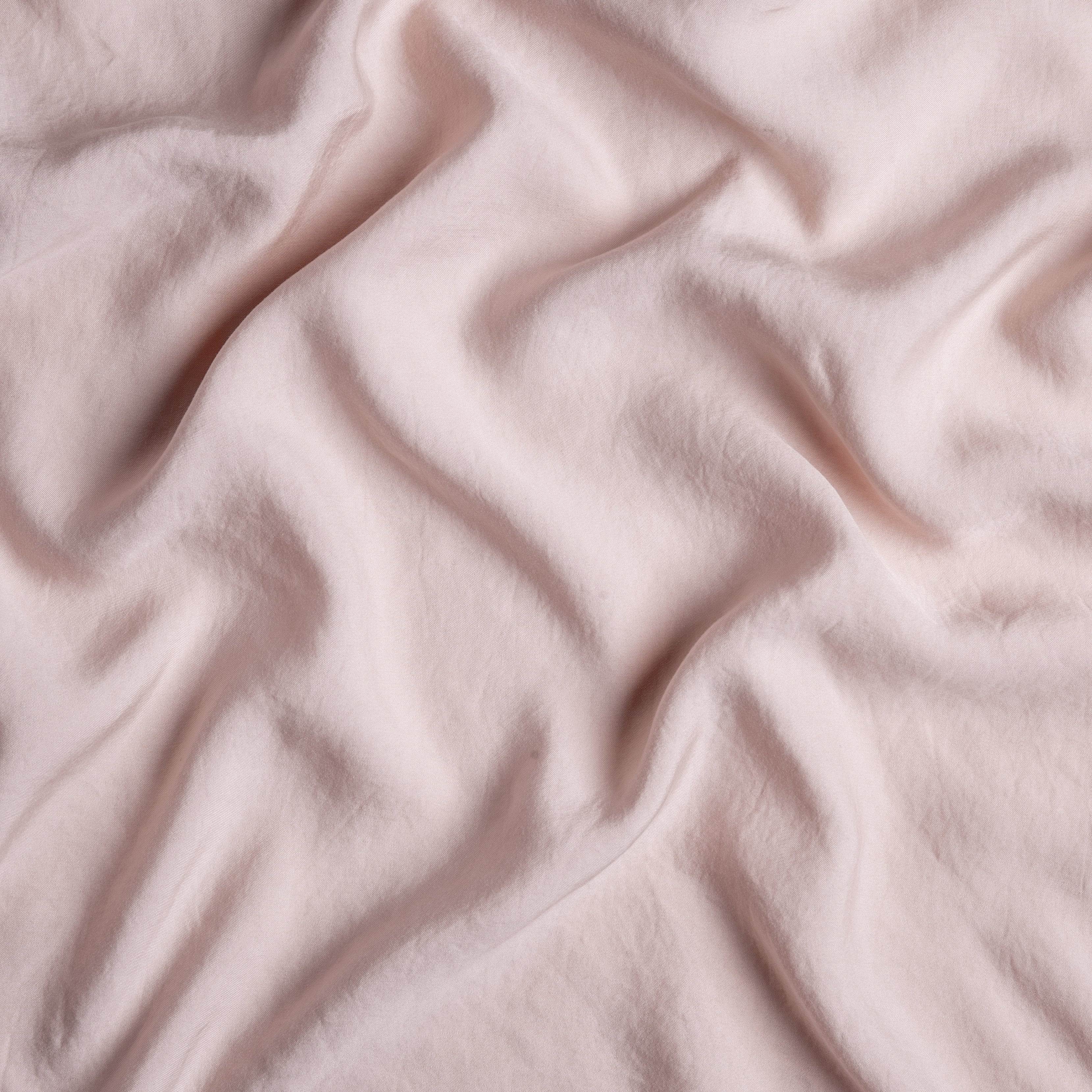 Rouge: A close up of Tencel™ fabric in rouge, a mid-tone blush pink.