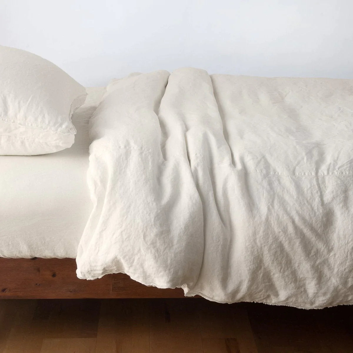 Parchment: Midweight linen duvet cover in parchment on a bed, side view.