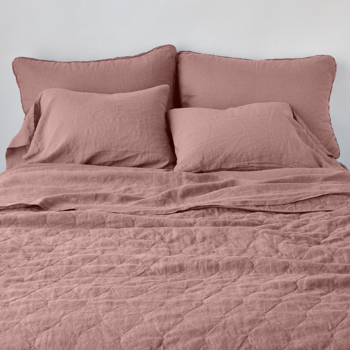 : Austin coverlet, end of bed view, with monochromatic sheeting and shams.