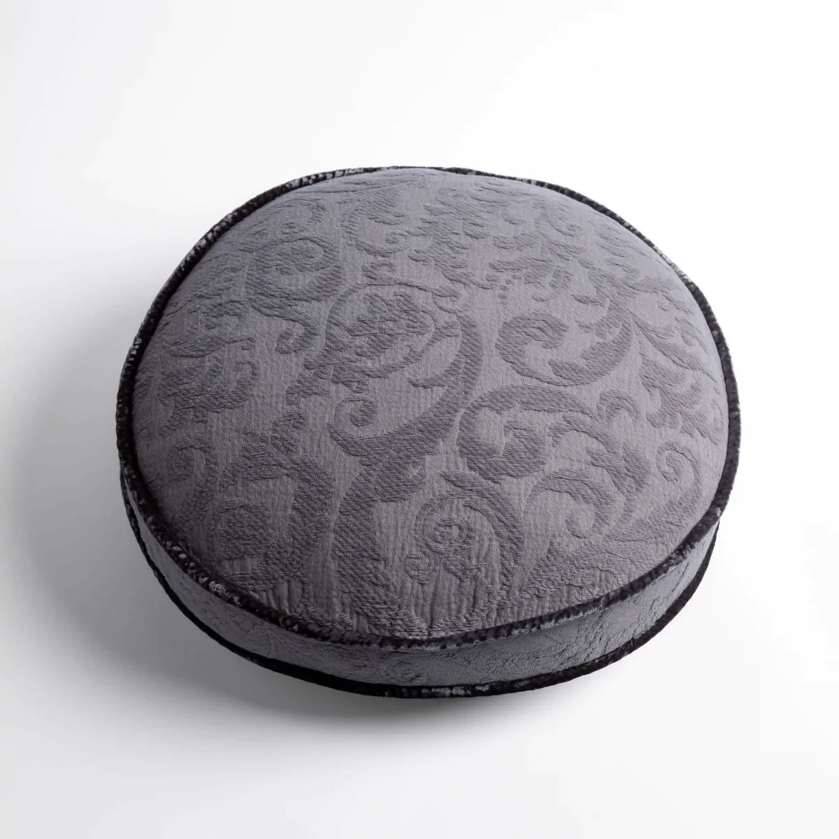 Moonlight: Organic cotton damask round pillow with silk velvet trim on white background β overhead angle.