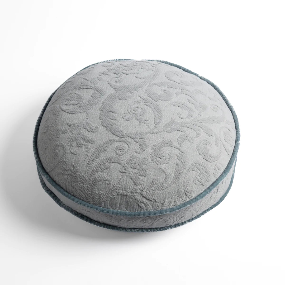 Cloud: Organic cotton damask round pillow with silk velvet trim on white background β overhead angle.