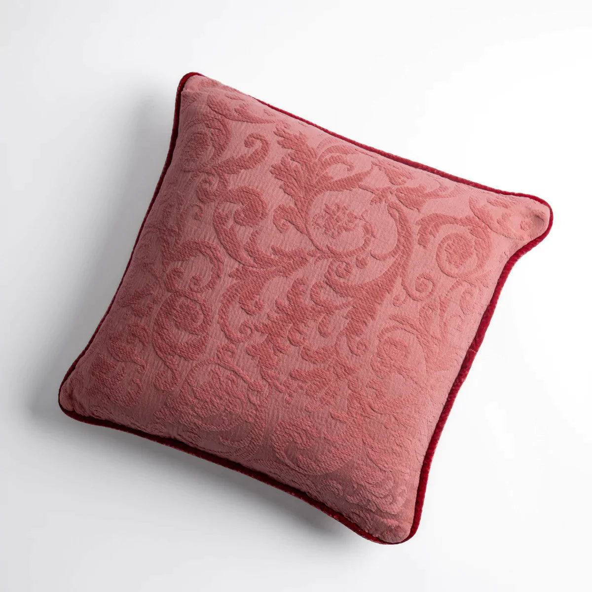 Poppy: Organic cotton damask square pillow with silk velvet trim on white background β overhead angle.