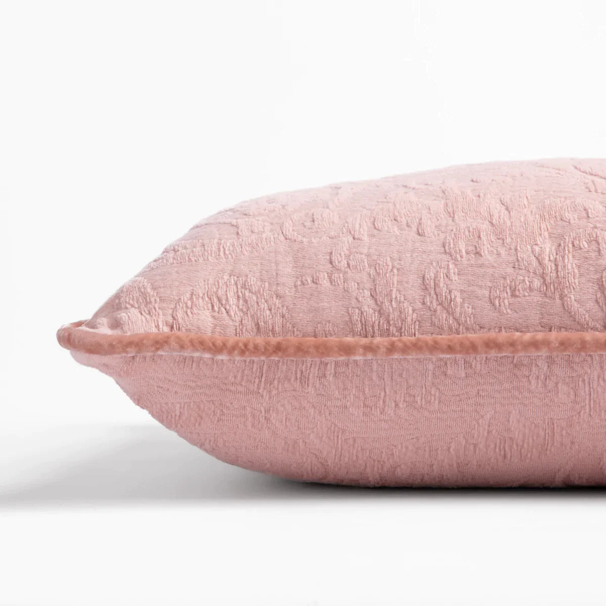 Rouge: Organic cotton damask square pillow with silk velvet trim on white background β side angle.