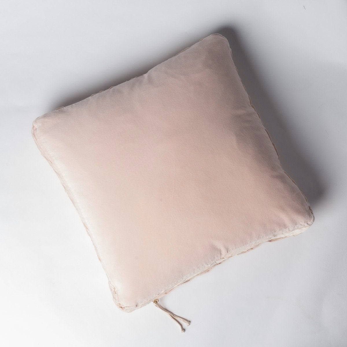 Pearl: Cotton velvet 24 by 24 pillow on a plain background - overhead view.