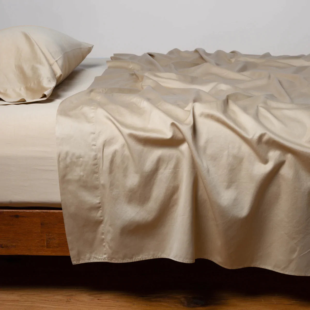 Honeycomb: Cotton sateen fitted sheet shown with matching flat sheet and sleeping pillow - side view.