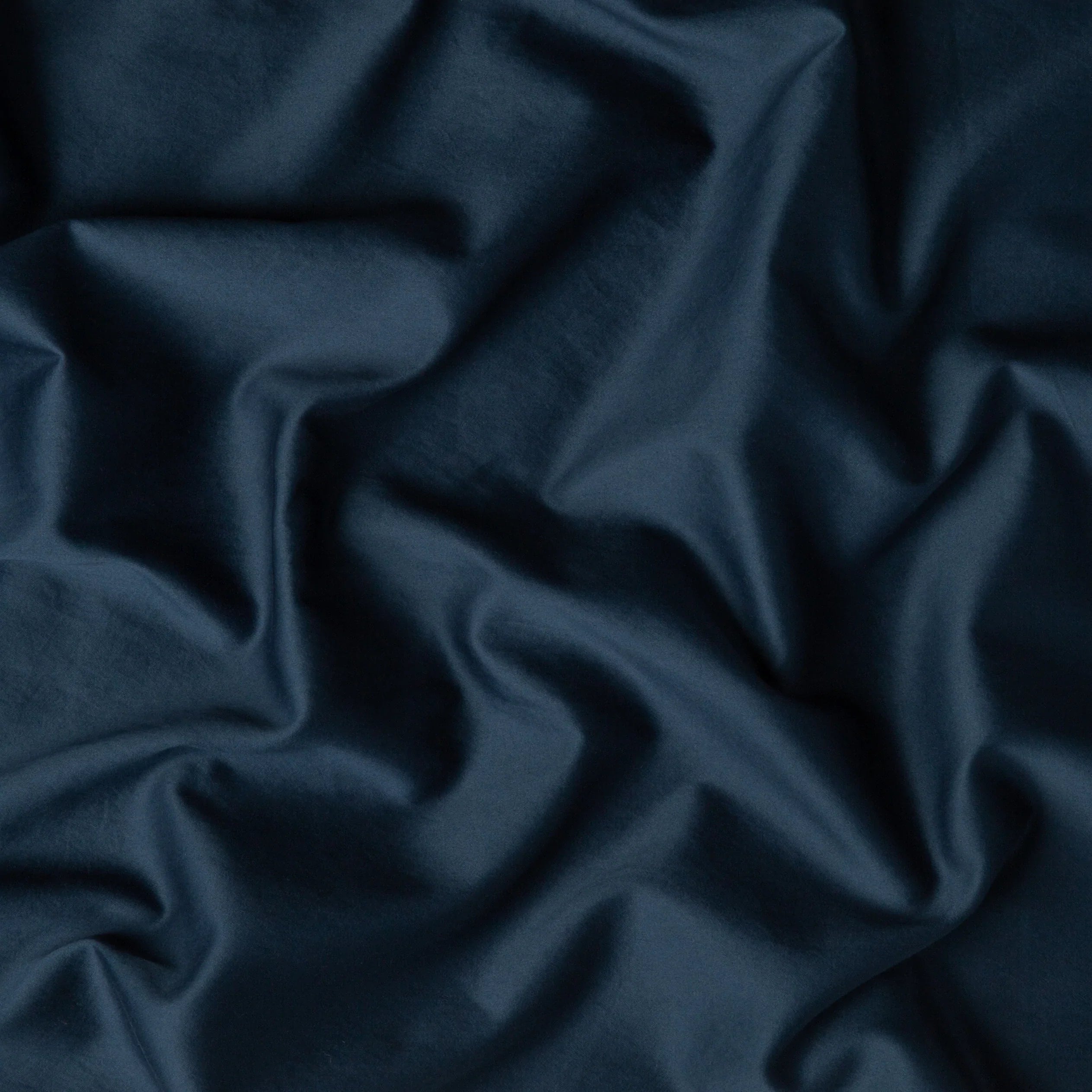 Midnight: A close up of cotton sateen fabric in midnight, a rich indigo tone.