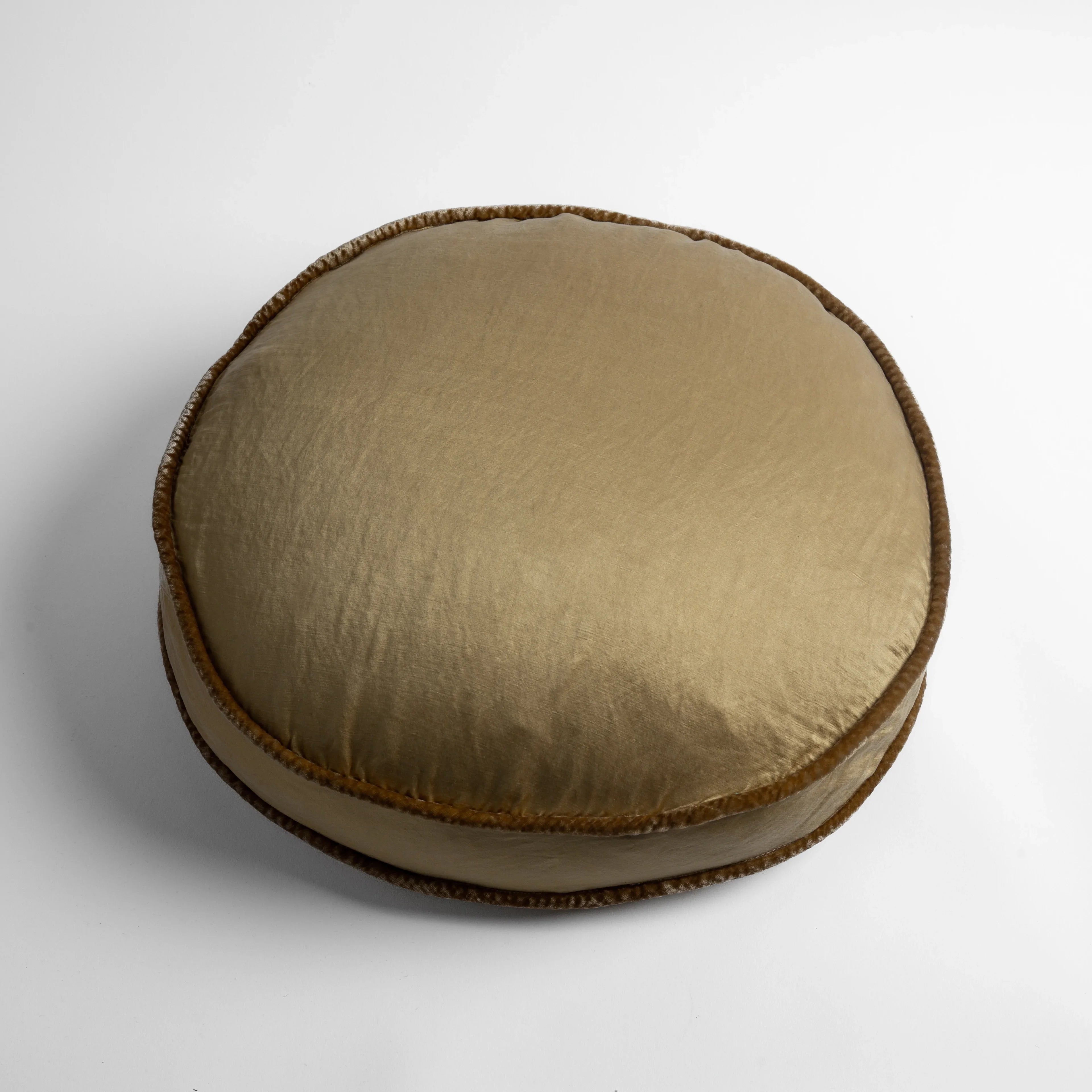 Honeycomb: 18" round charmeuse pillow with silk velvet trim at gusset shot from overhead on a white background