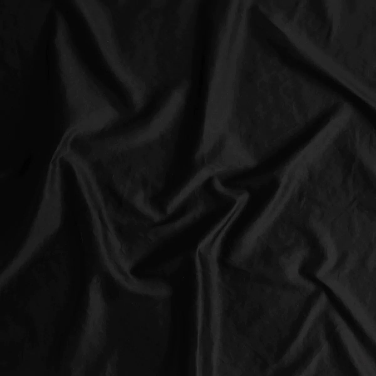 Corvino: A close up of cotton sateen fabric in Corvino, a black tone