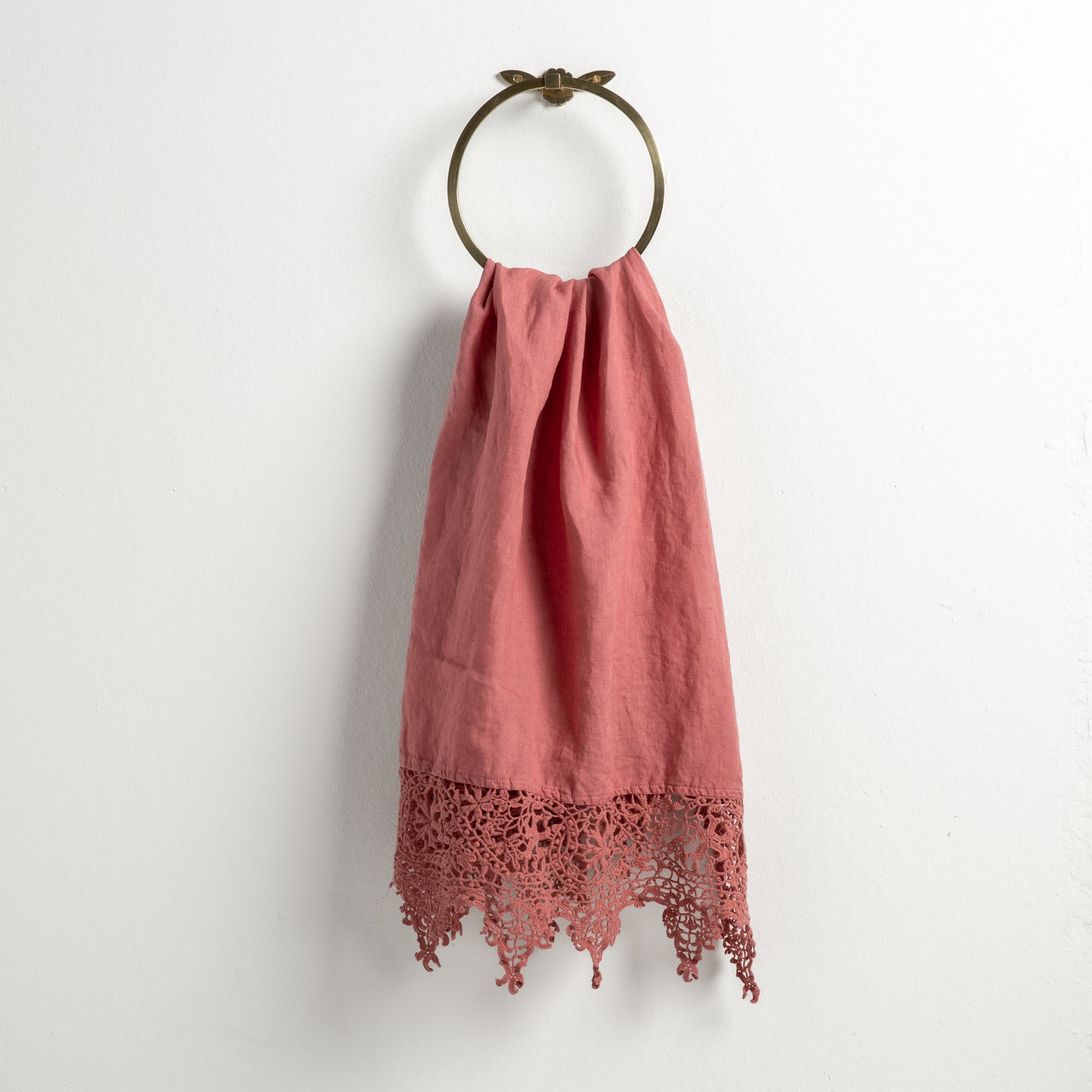 Poppy: Lace trimmed linen guest towel draped through a decorative towel ring against a plain white background.