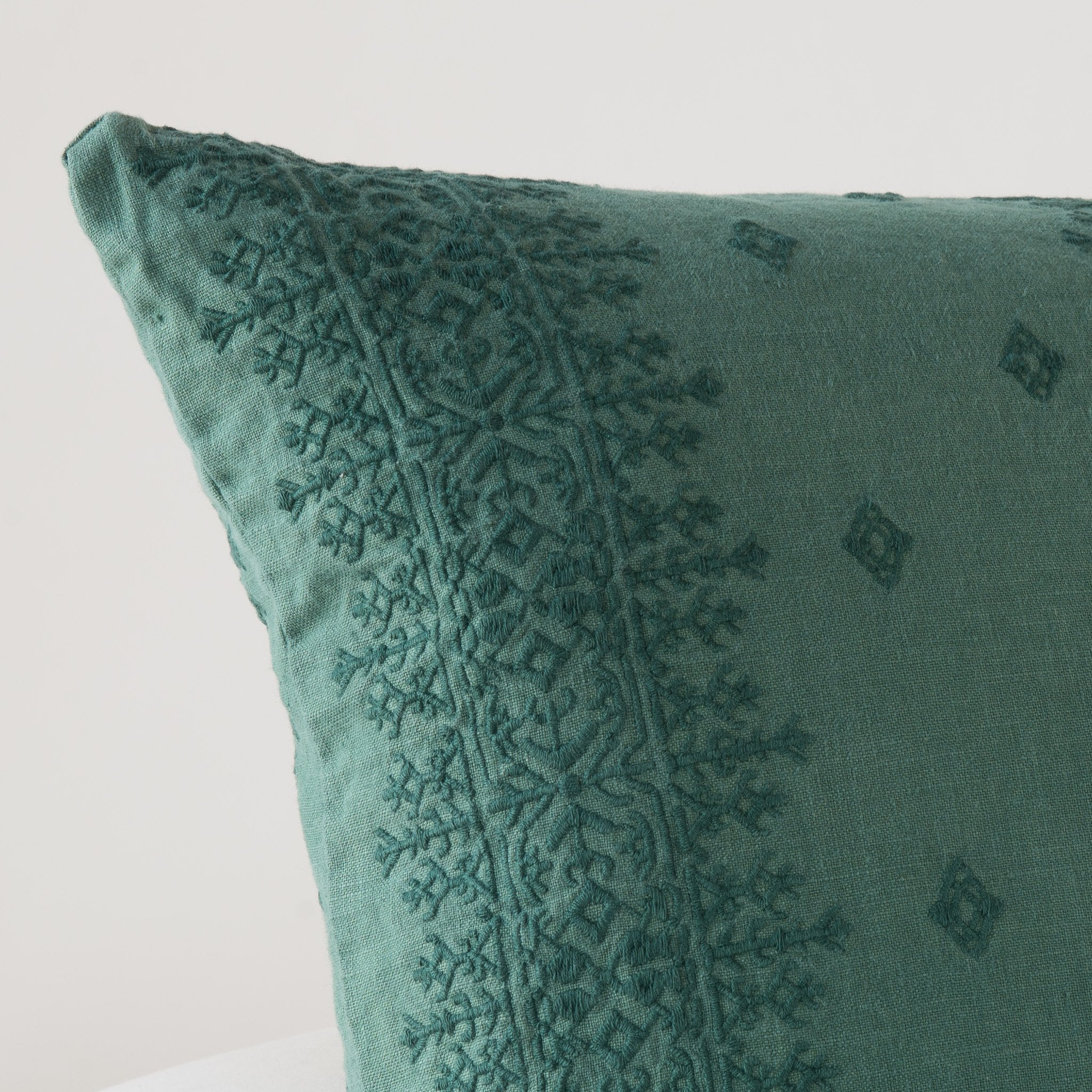 Jade: Close-up of pillow corner, showcasing the embroidery pattern detail.