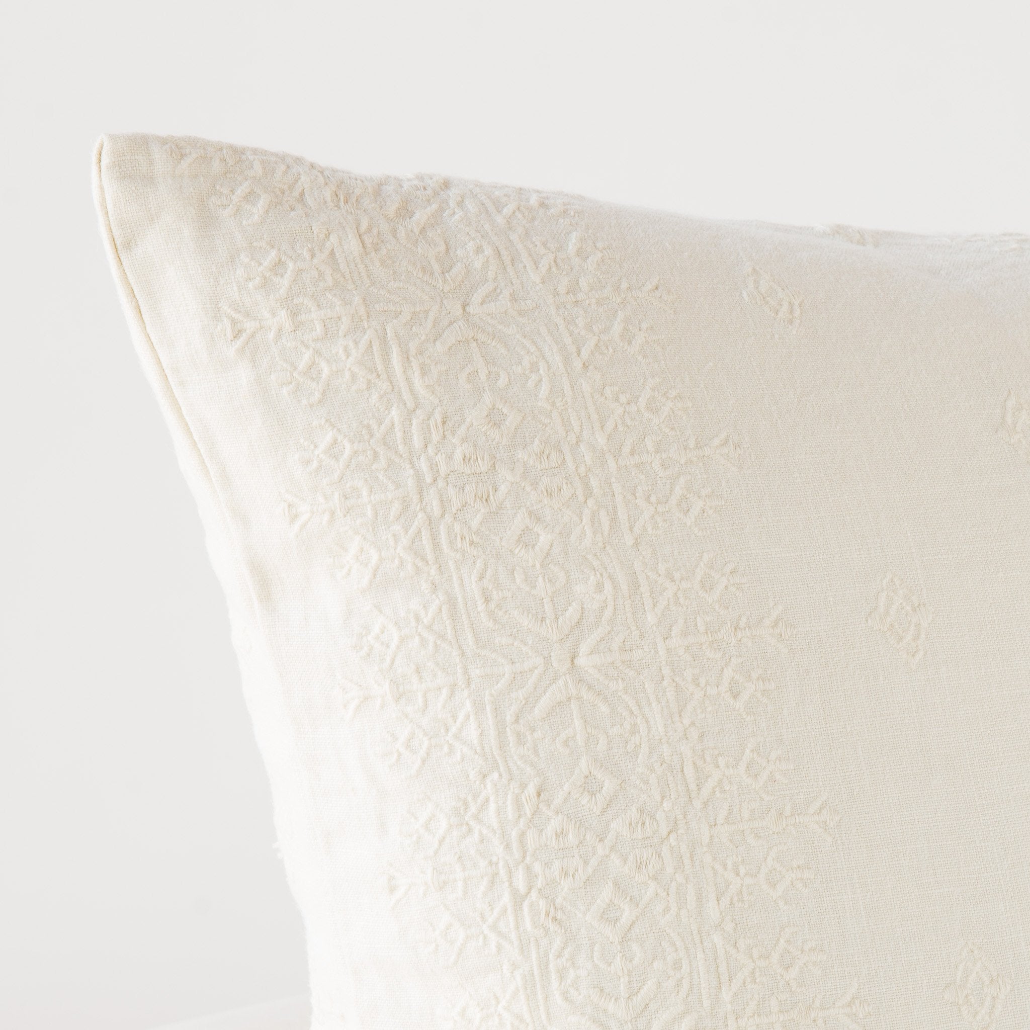 Parchment: Close-up of pillow corner, showcasing the embroidery pattern detail.
