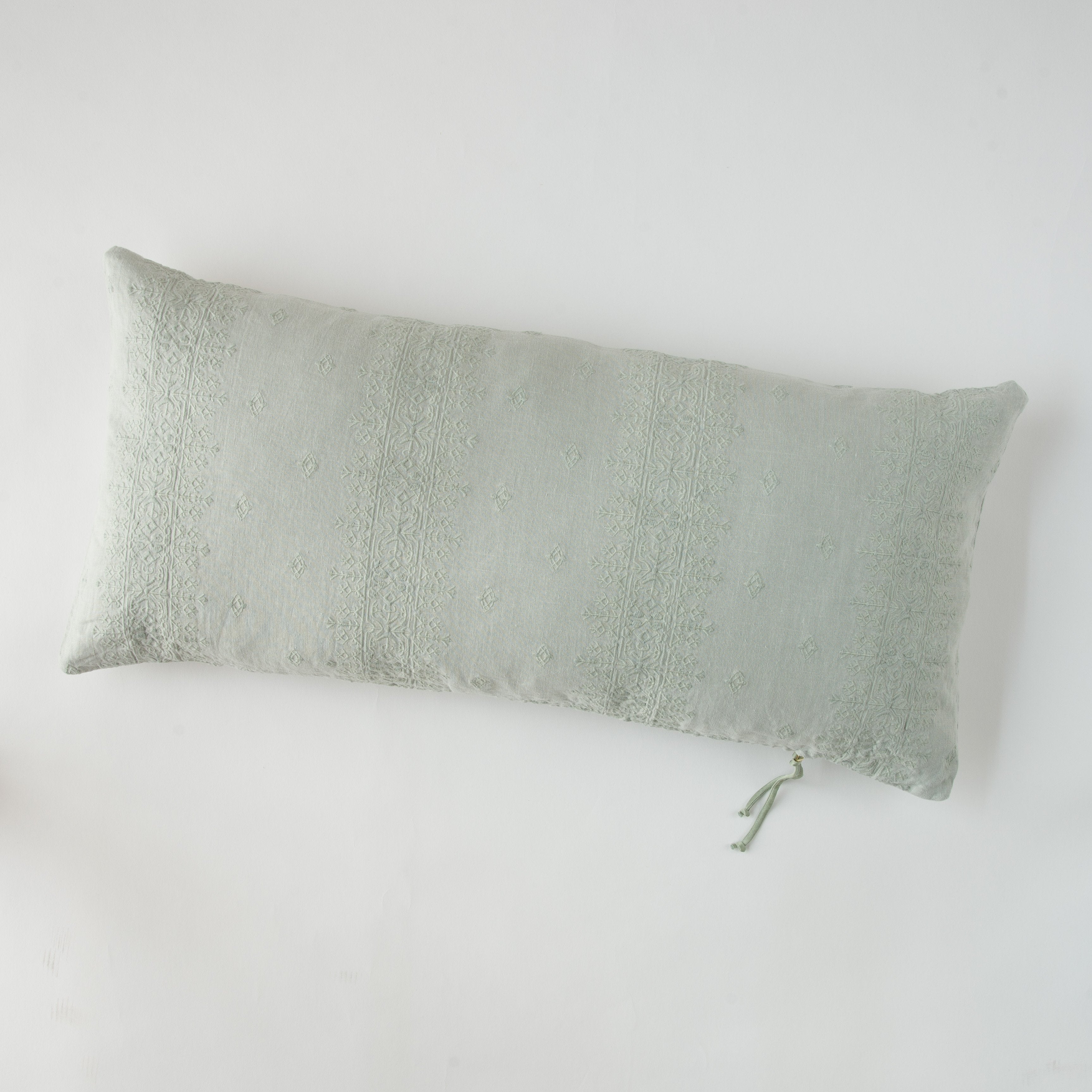 Eucalyptus: embroidered midweight linen 16x36 pilow overhead on a white background.