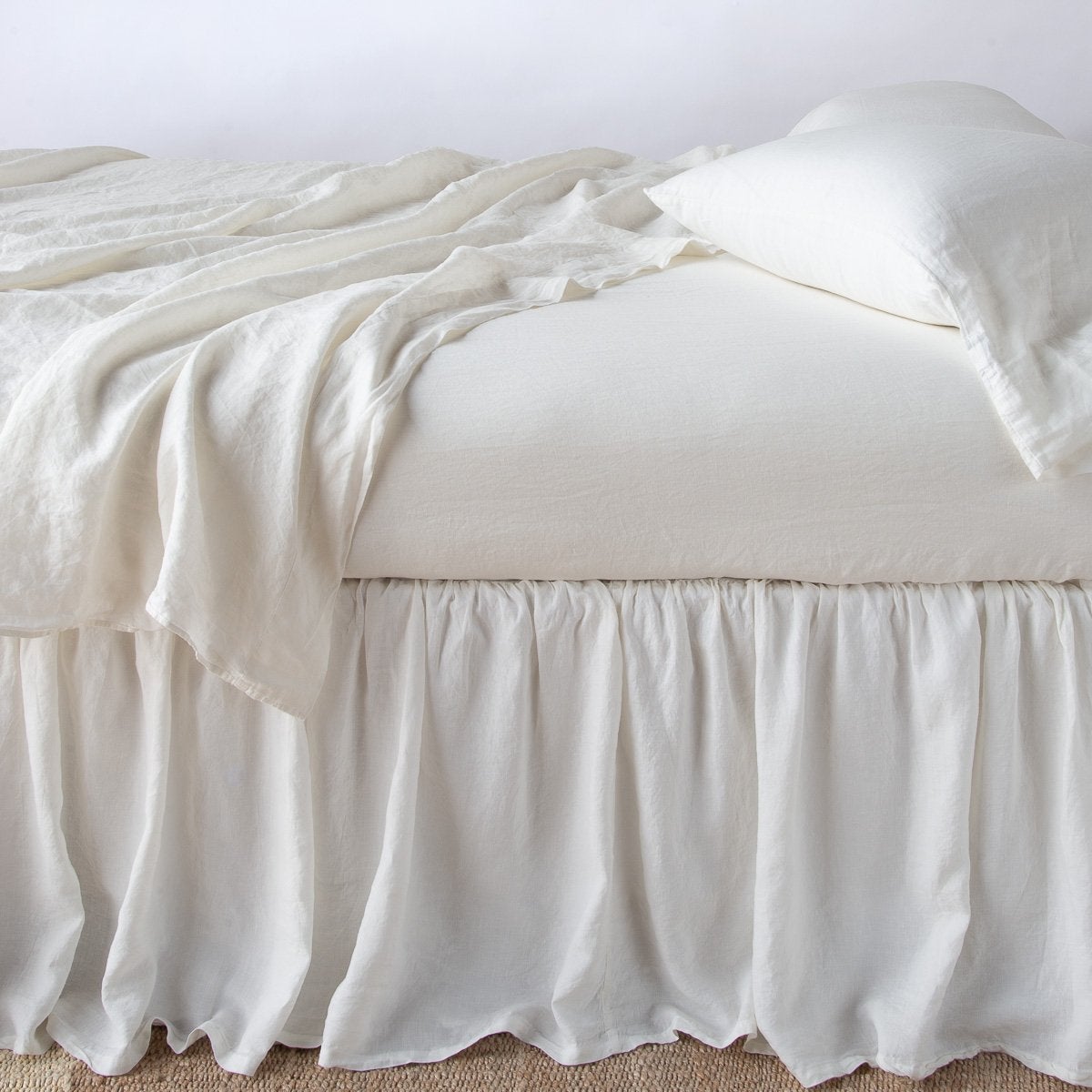 Winter White: bed skirt with matching rumpled sheets and sleeping pillows - side view.
