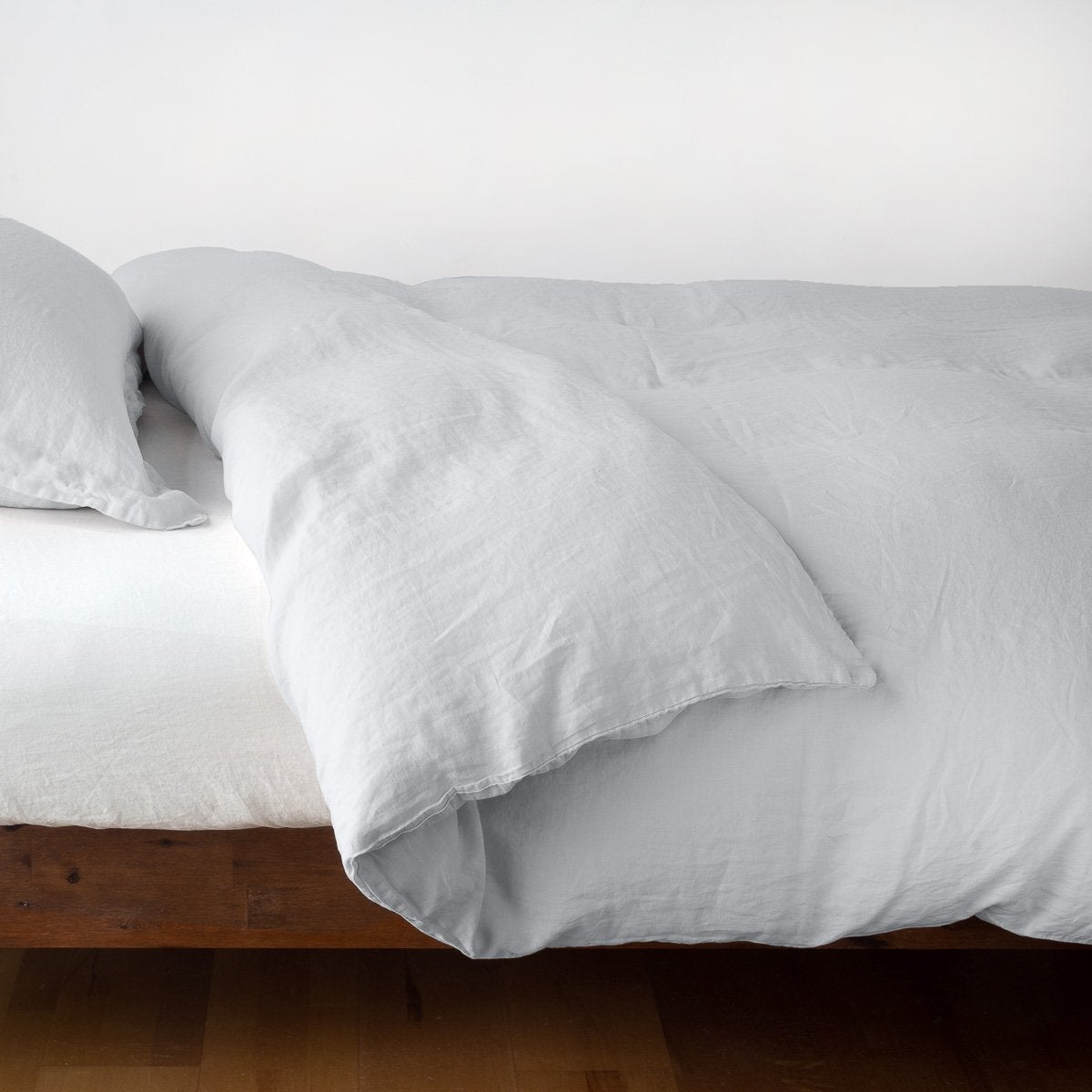 Sterling: duvet cover neatly folded back over white linen sheeting - side view.