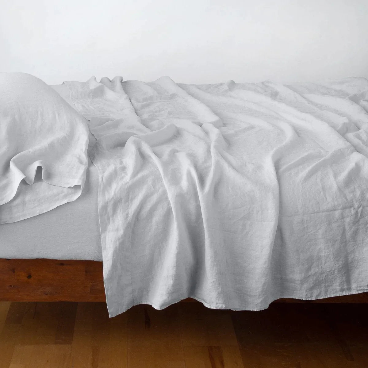 Sterling: fitted sheet with matching rumpled flat sheet and sleeping pillow - side view.