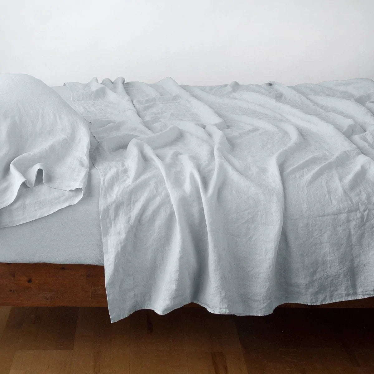 Cloud: Rumpled linen sheeting with matching sleeping pillow - side view.