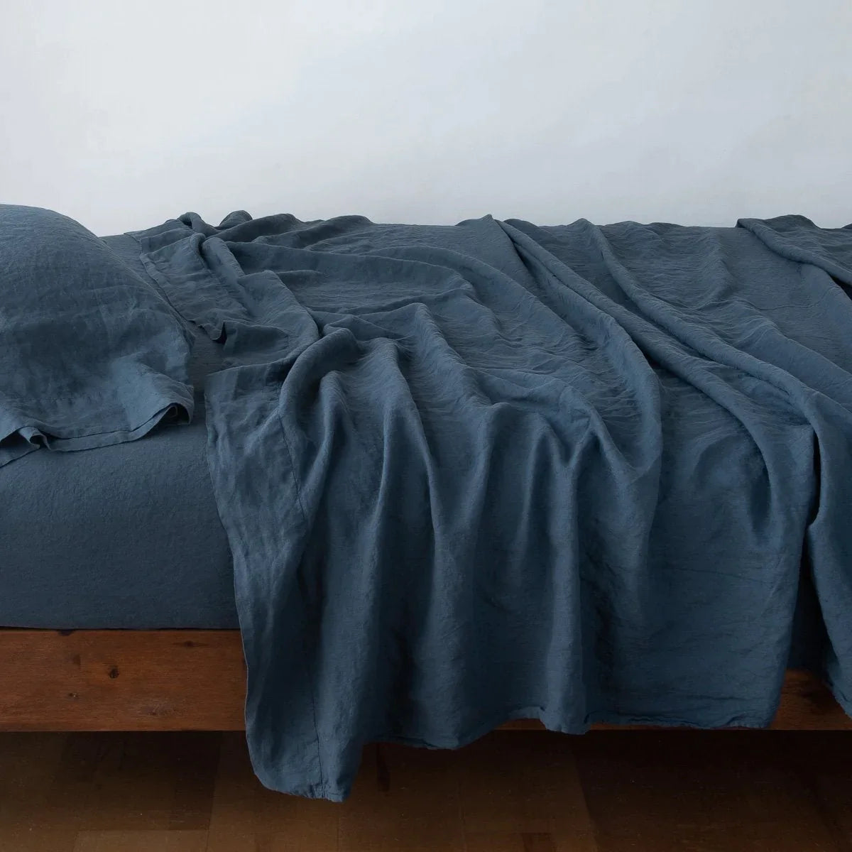 Midnight: Rumpled linen sheeting with matching sleeping pillow - side view.