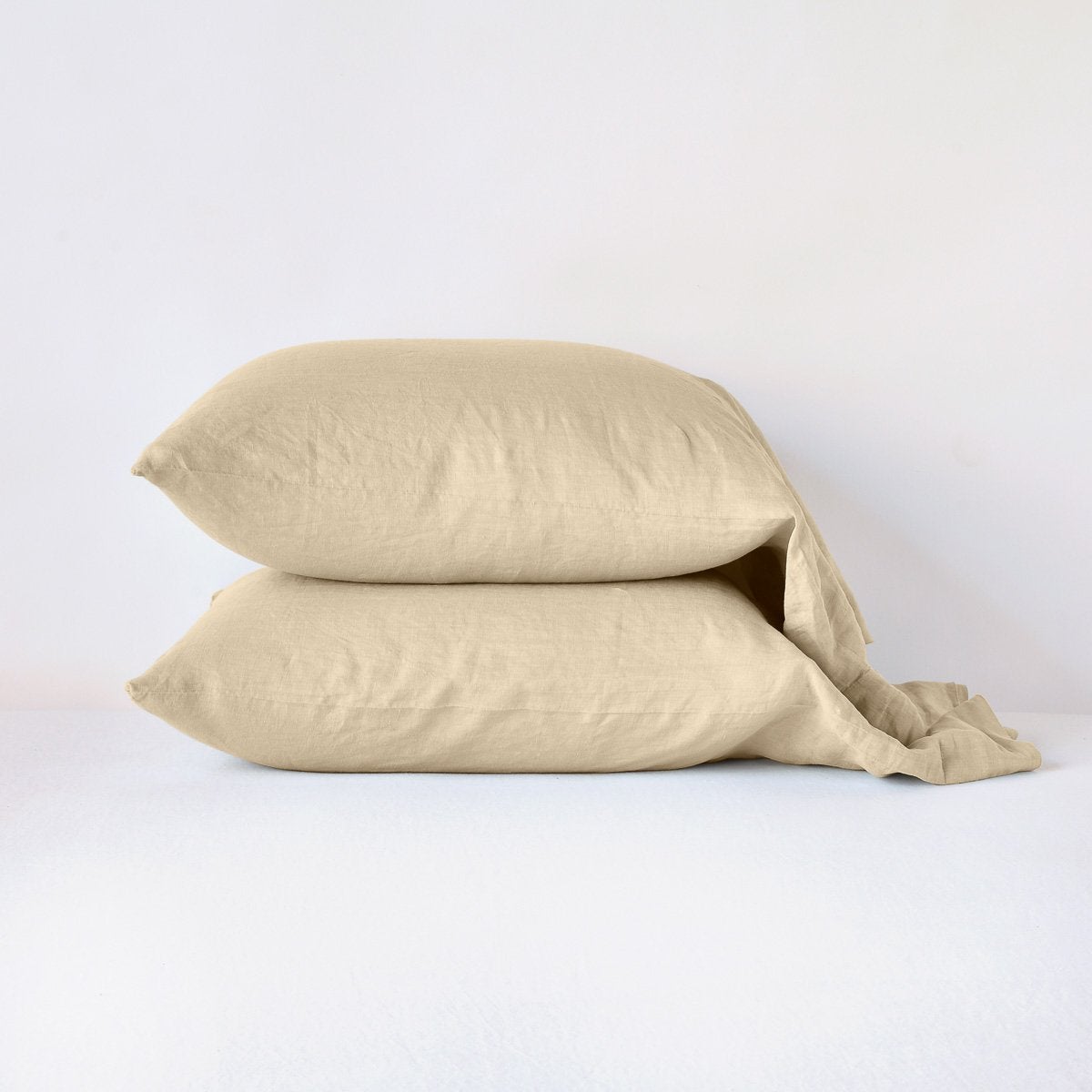 Honeycomb: Two sleeping pillows neatly stacked against a white background - side view.