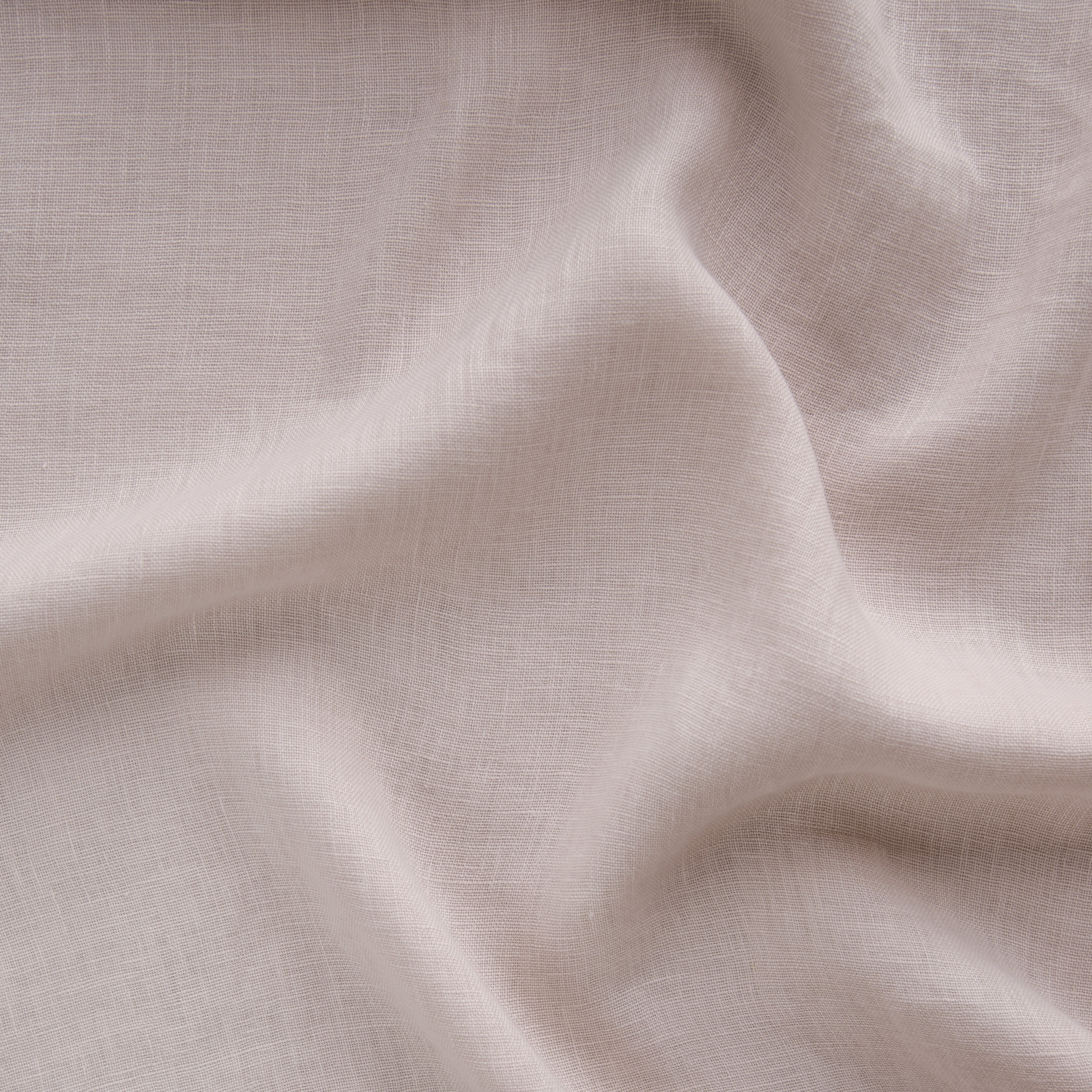 Pearl: A close up of linen whisper, our lightweight linen gauze, in pearl, a nude-like, soft rose pink tone.