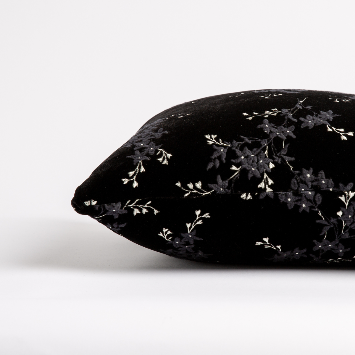 Corvino: side view of pillow showing front and back, straight on against a white background.