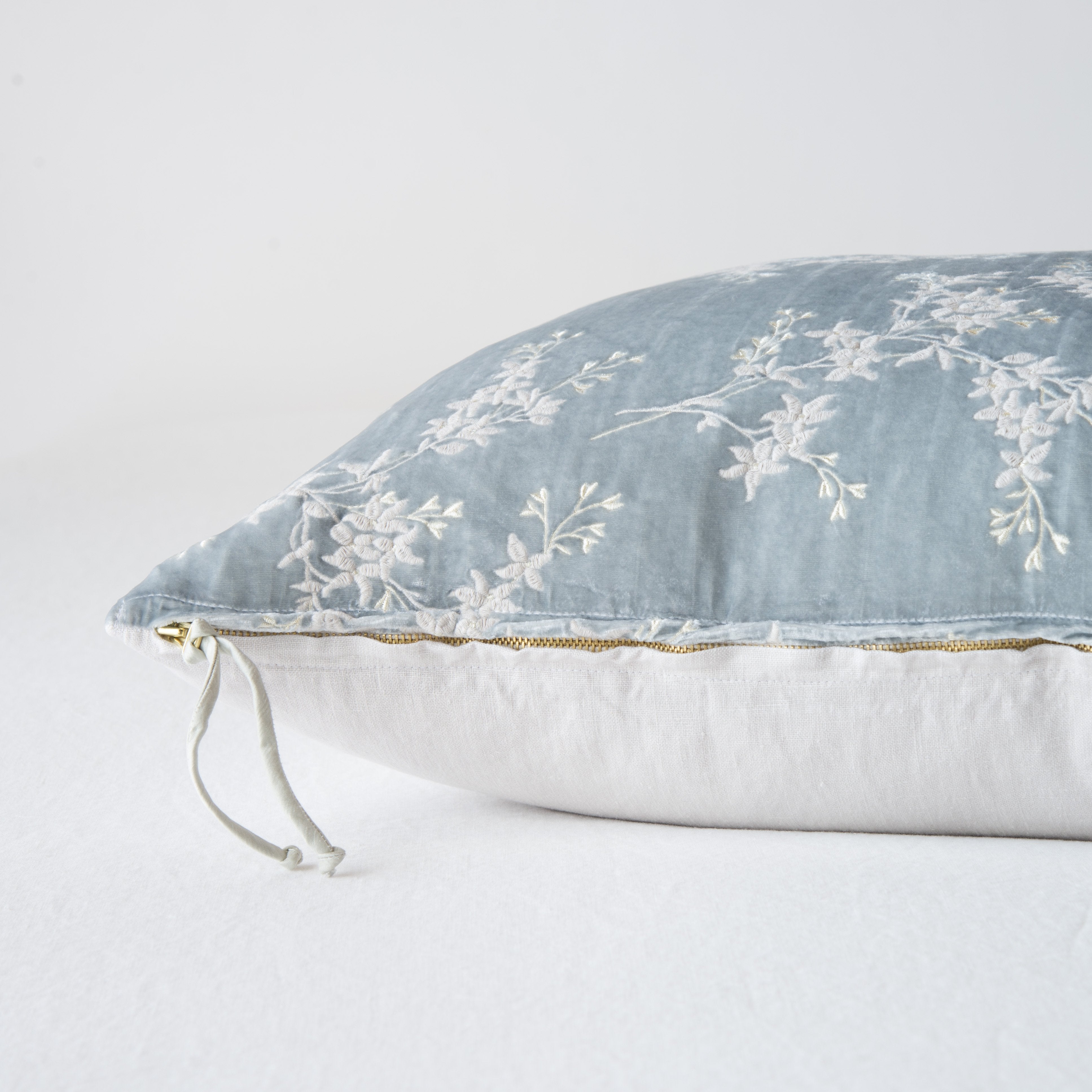 Sterling: Close-up side vew featuring brass zipper with charmeuse pull and linen back.