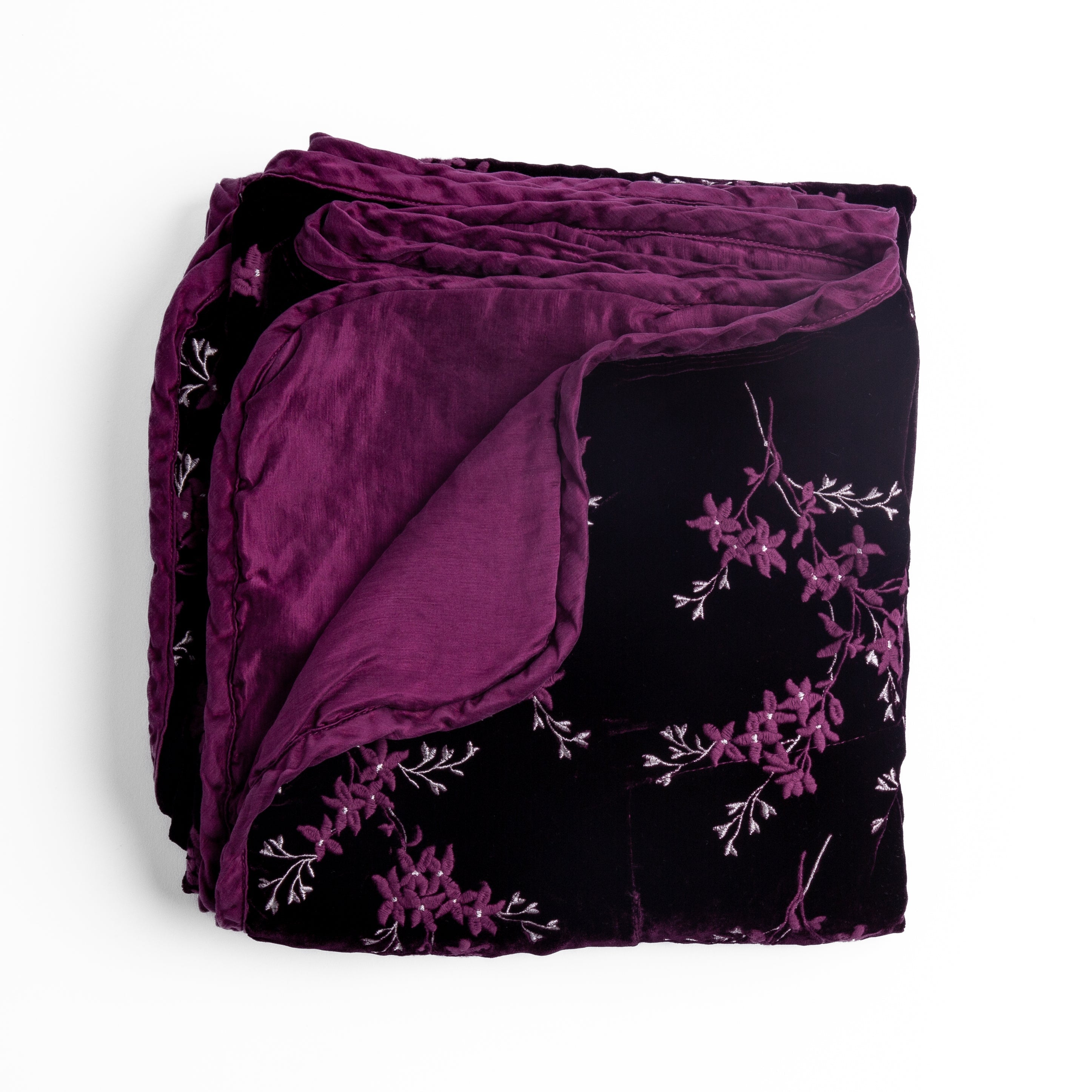 Fig: overhead angle of the folded blanket with a corner pulled back to show the reverse and trim.