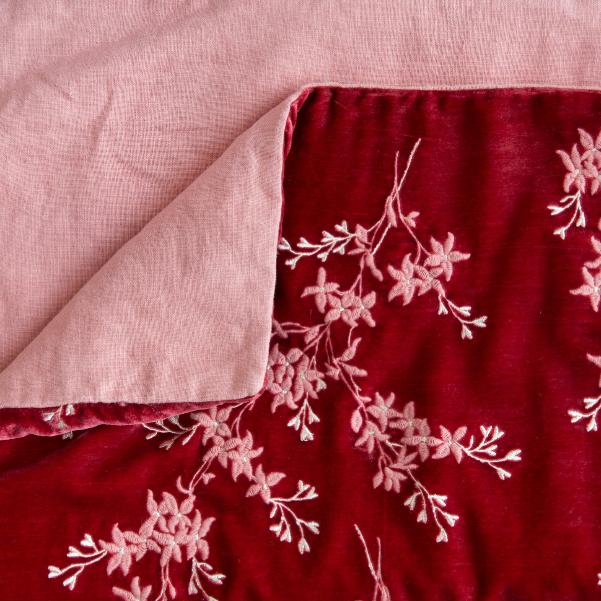 Poppy: Close up of blanket, with a corner turned back to showcase the linen back - overhead view.