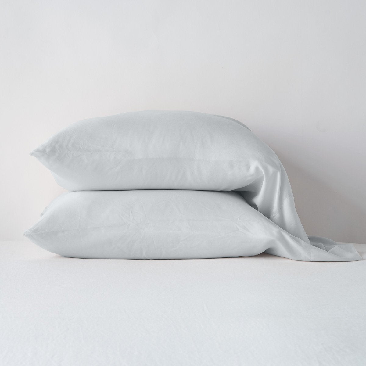 Cloud: sleeping pillows stacked neatly against a white backdrop - side view.