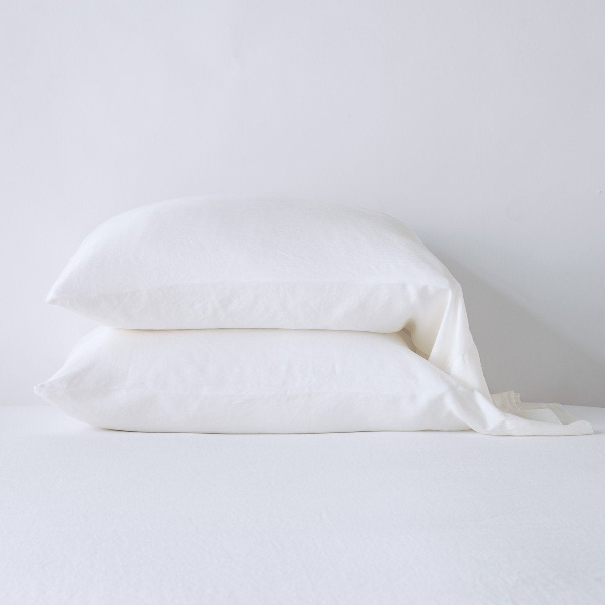 Winter White: sleeping pillows stacked neatly against a white backdrop - side view.