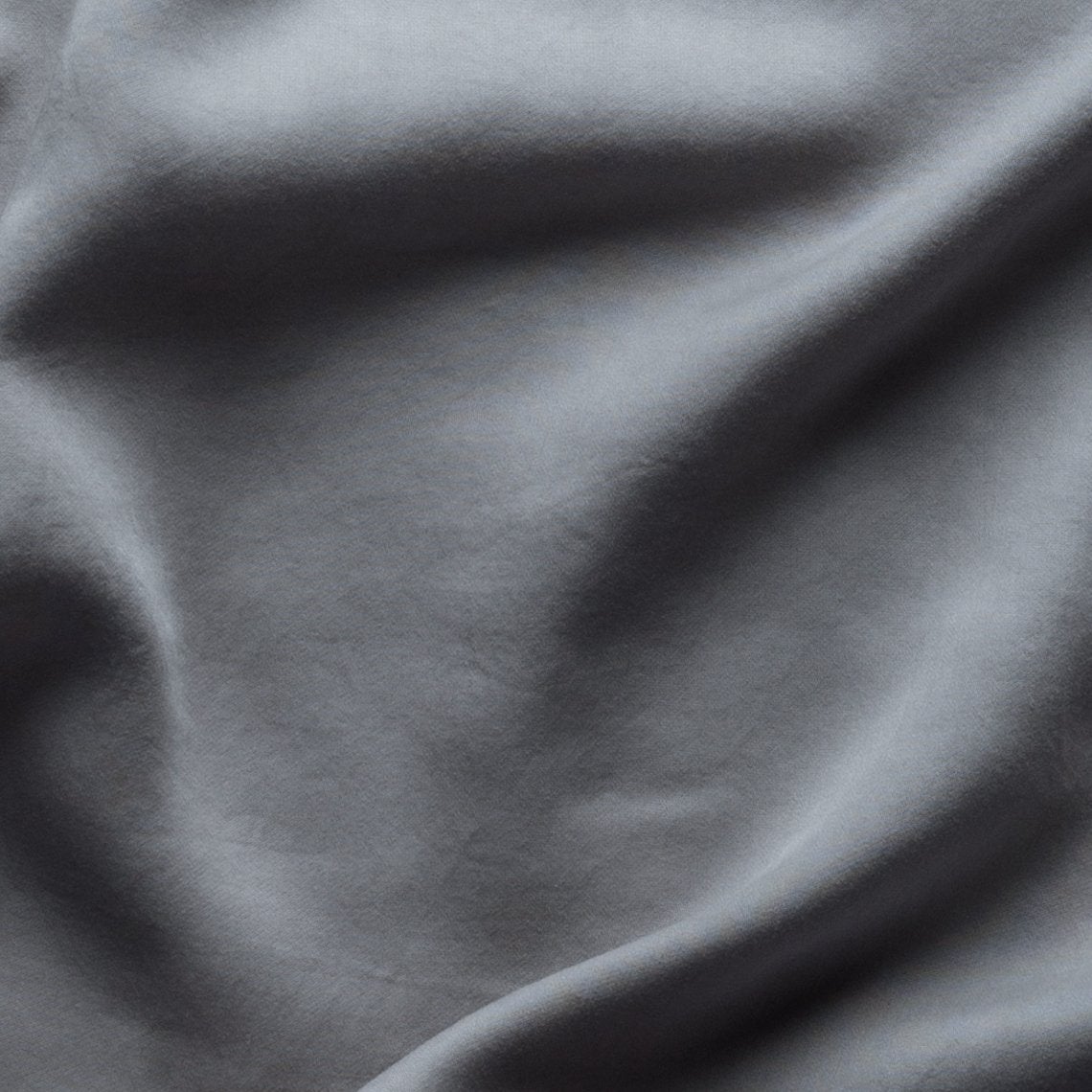 Moonlight: A close up of Tencel™ fabric in moonlight, a saturated, cool, mid-dark grey tone.