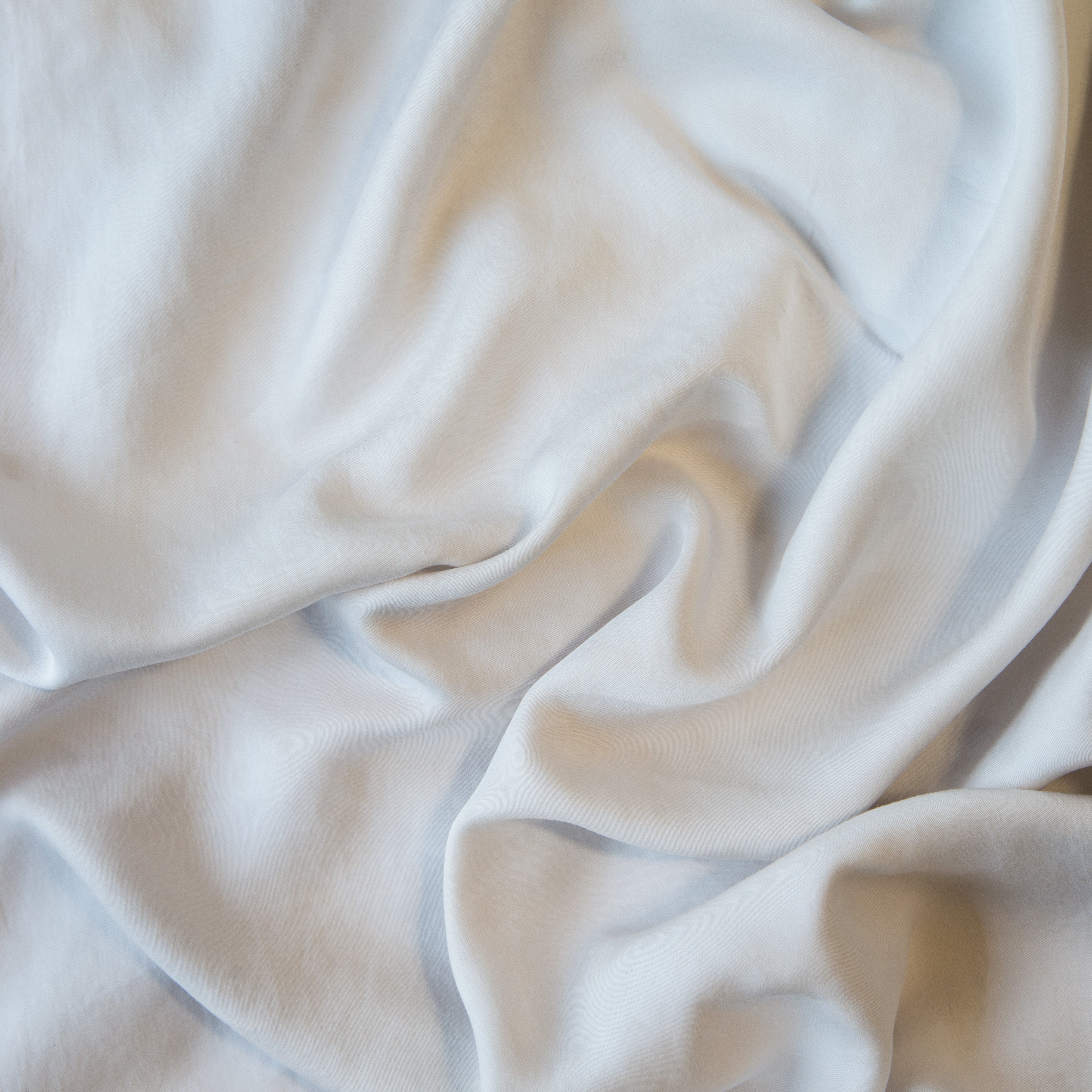 Sterling: A close up of Tencel™ fabric in sterling, a silvery neutral light grey.