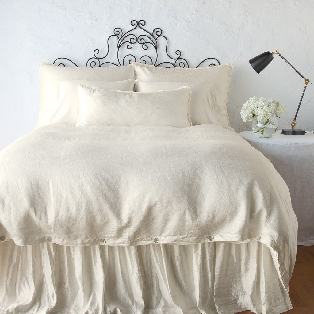 Parchment: bed skirt with matching duvet and pillows - end of bed view.