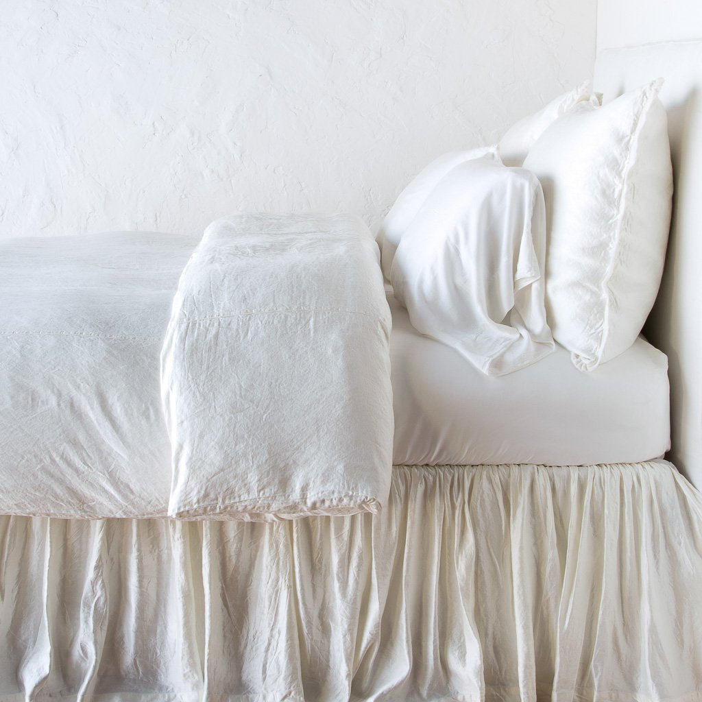 Winter White: duvet cover with matching pillows and bed skirt - side view.