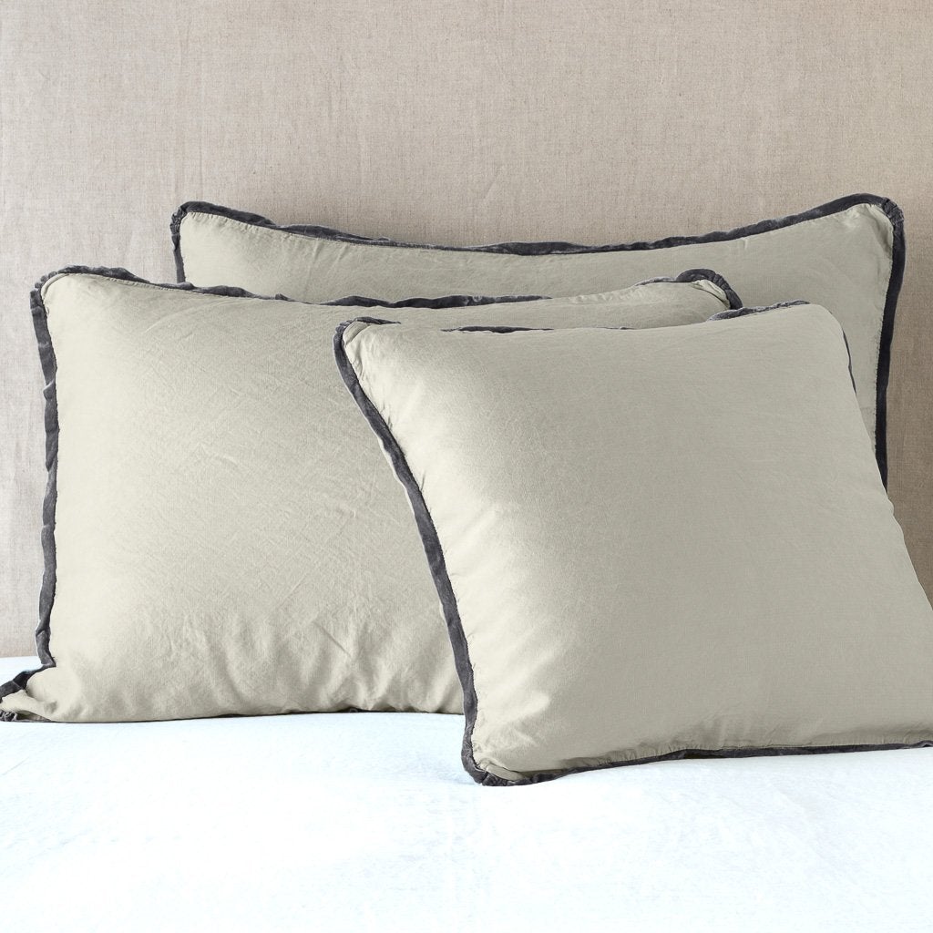 : Paloma shams leaning upright on white sheeting against a neutral headboard - fog.