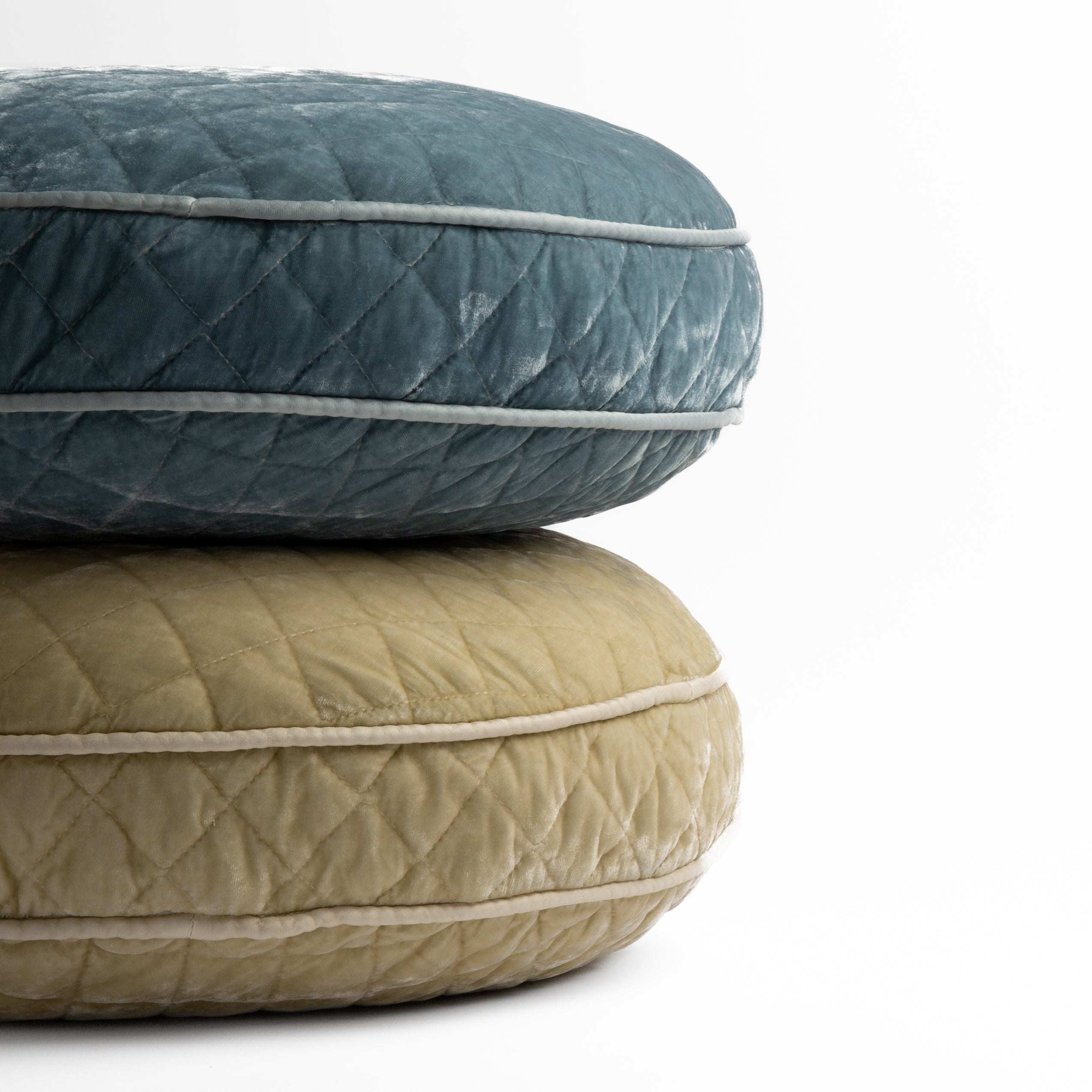 : two 18" round pillows stacked and shot straight on against a white background, pillows shown in Cloud and Parchment