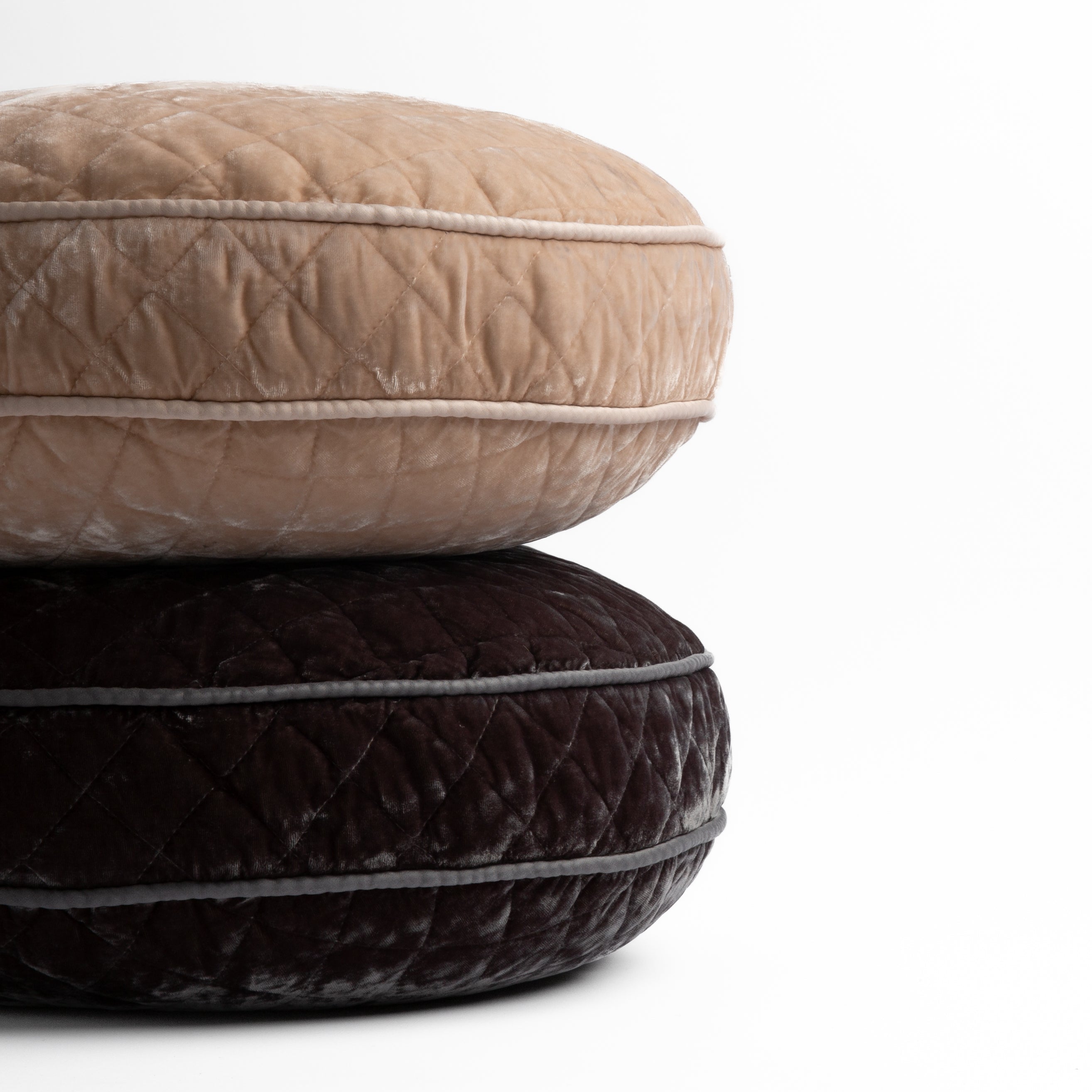 : two 18" round pillows stacked and shot straight on against a white background, pillows shown in Pearl and Moonlight.