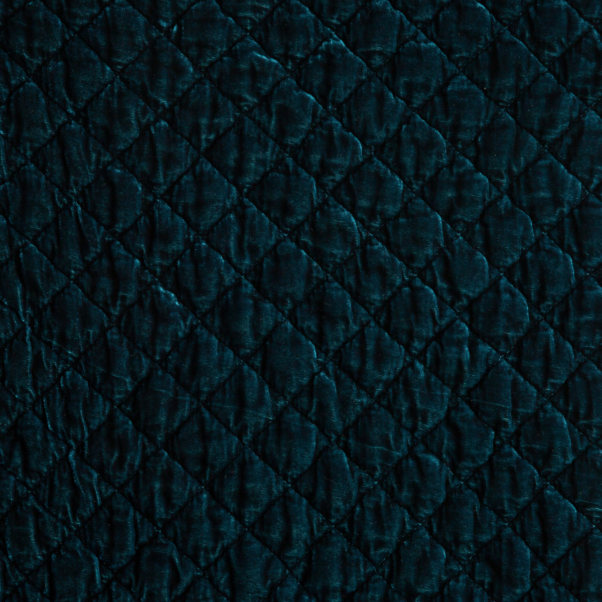 Cenote: Close-up of quilted silk velvet in cenote, a vibrant, ocean-inspired blue-green.