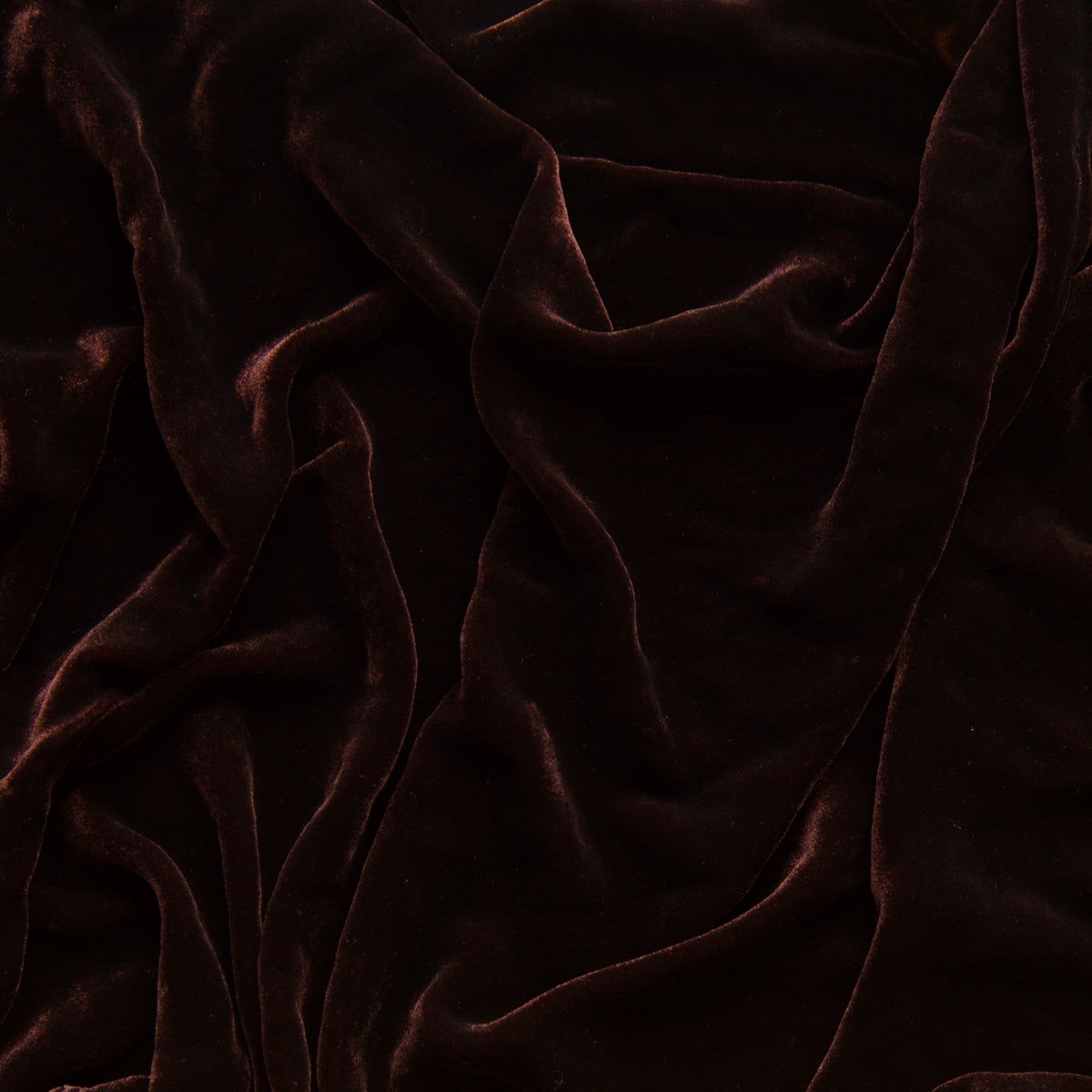 Mahogany: A close up of silk velvet in mahogany, a deep, earthen, reddish brown.