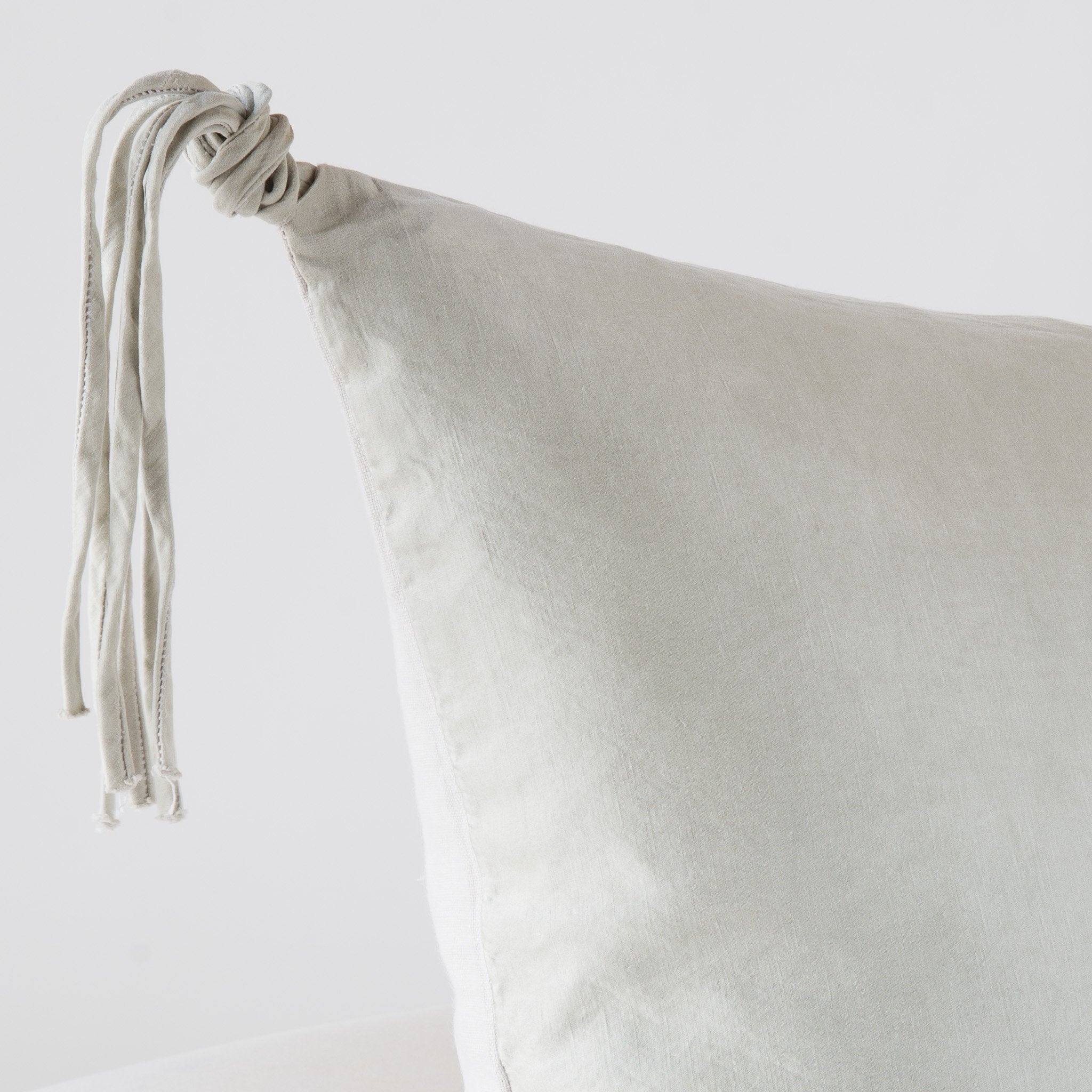 Sterling: Corner detail close-up, highlighting hand-tied charmeuse tassel.