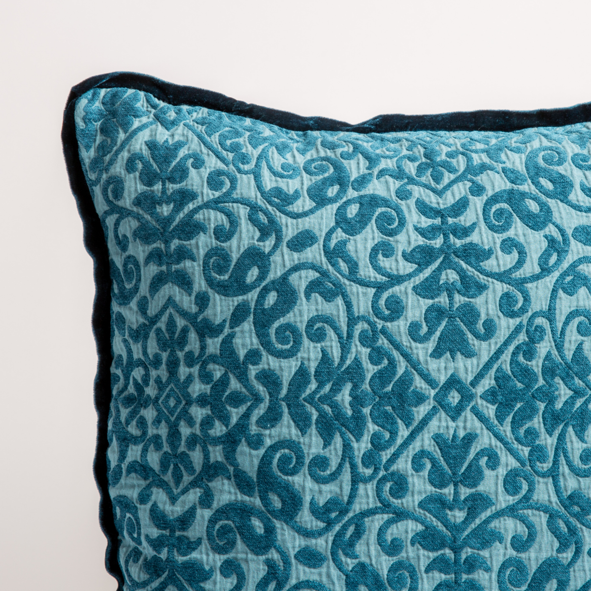 Cenote: a close up of a vienna throw pillow corner, showing trim and pattern detail β straight on against a white background.