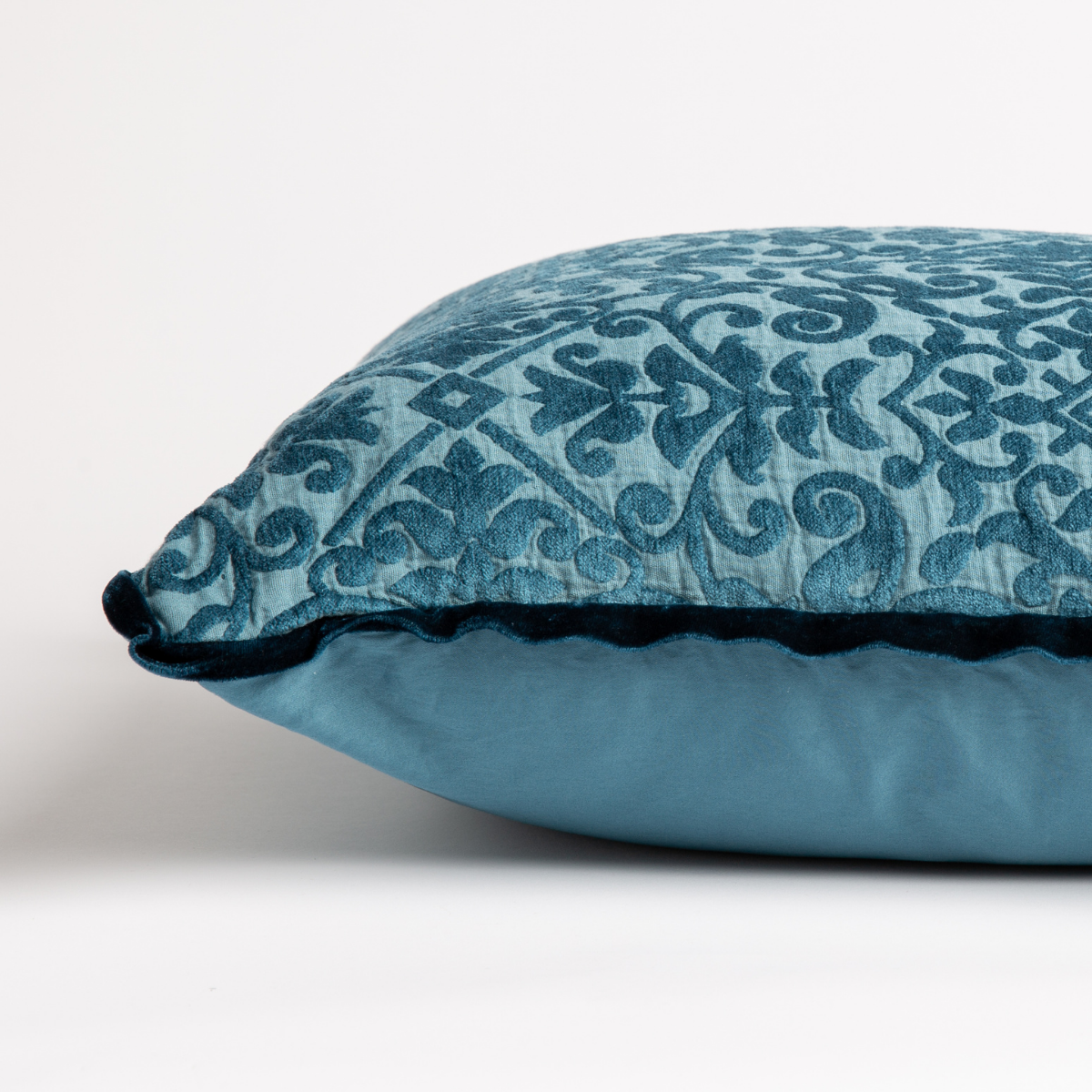 Cenote: side view of 18x18 pillow shows cotton sateen back and silk velvet trim detail β close up against a white background.