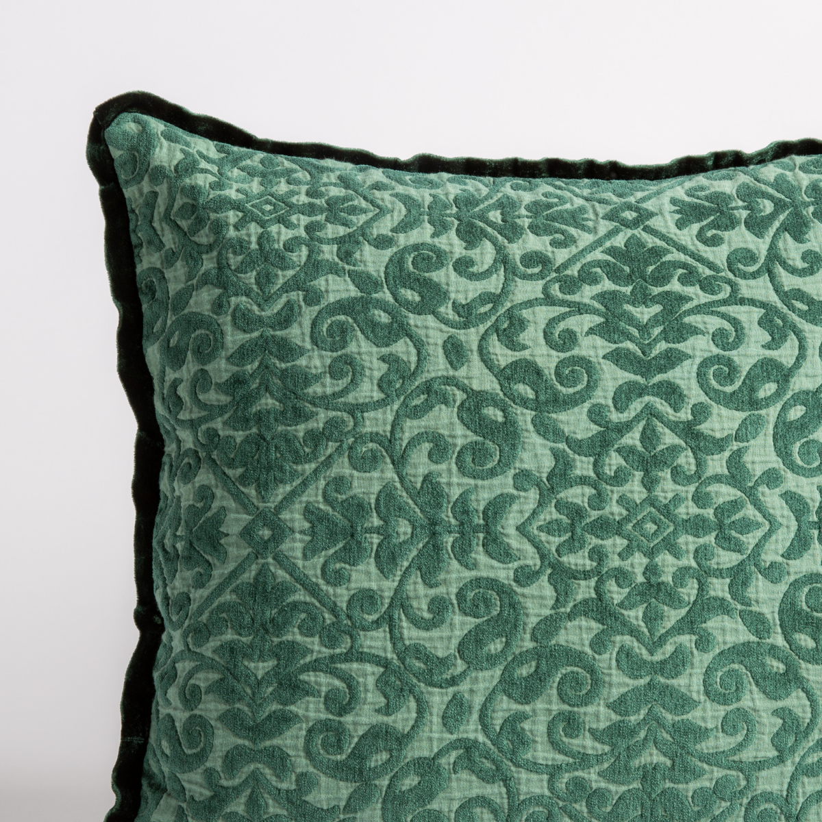 Jade: a close up of a vienna throw pillow corner, showing trim and pattern detail β straight on against a white background.