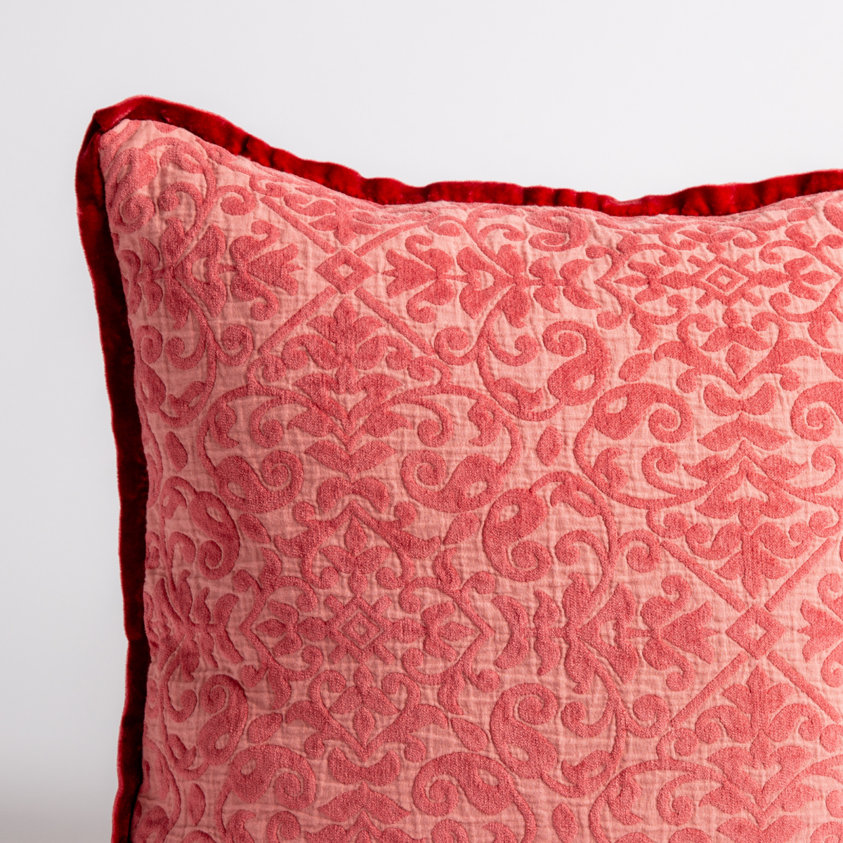 Poppy: a close up of a vienna throw pillow corner, showing trim and pattern detail β straight on against a white background.