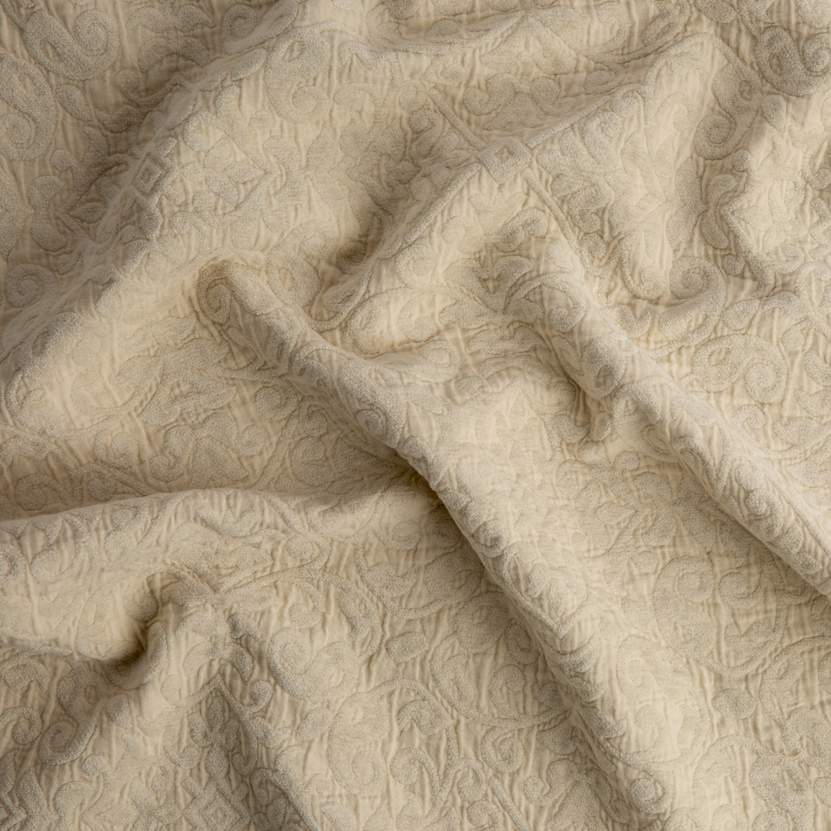 Parchment: A close up of Vienna cotton chenille jacquard in parchment, a warm, antiqued cream.