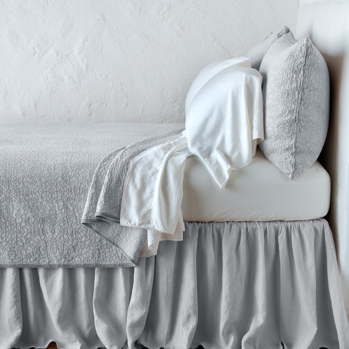 Sterling: Cotton chenille jacquard coverlet and matching sham over white sheeting - side view.