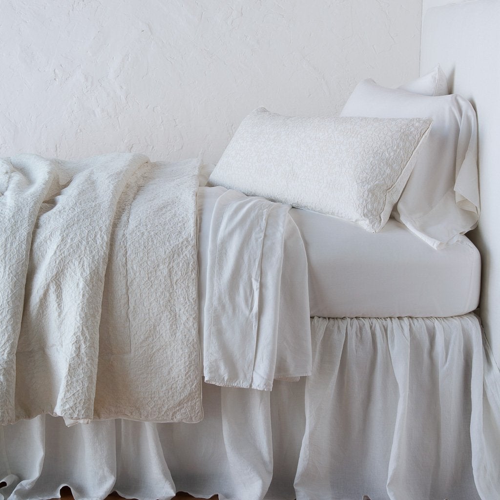Winter White: Vienna 16x36 and matching coverlet over white sheeting - winter white, side view.